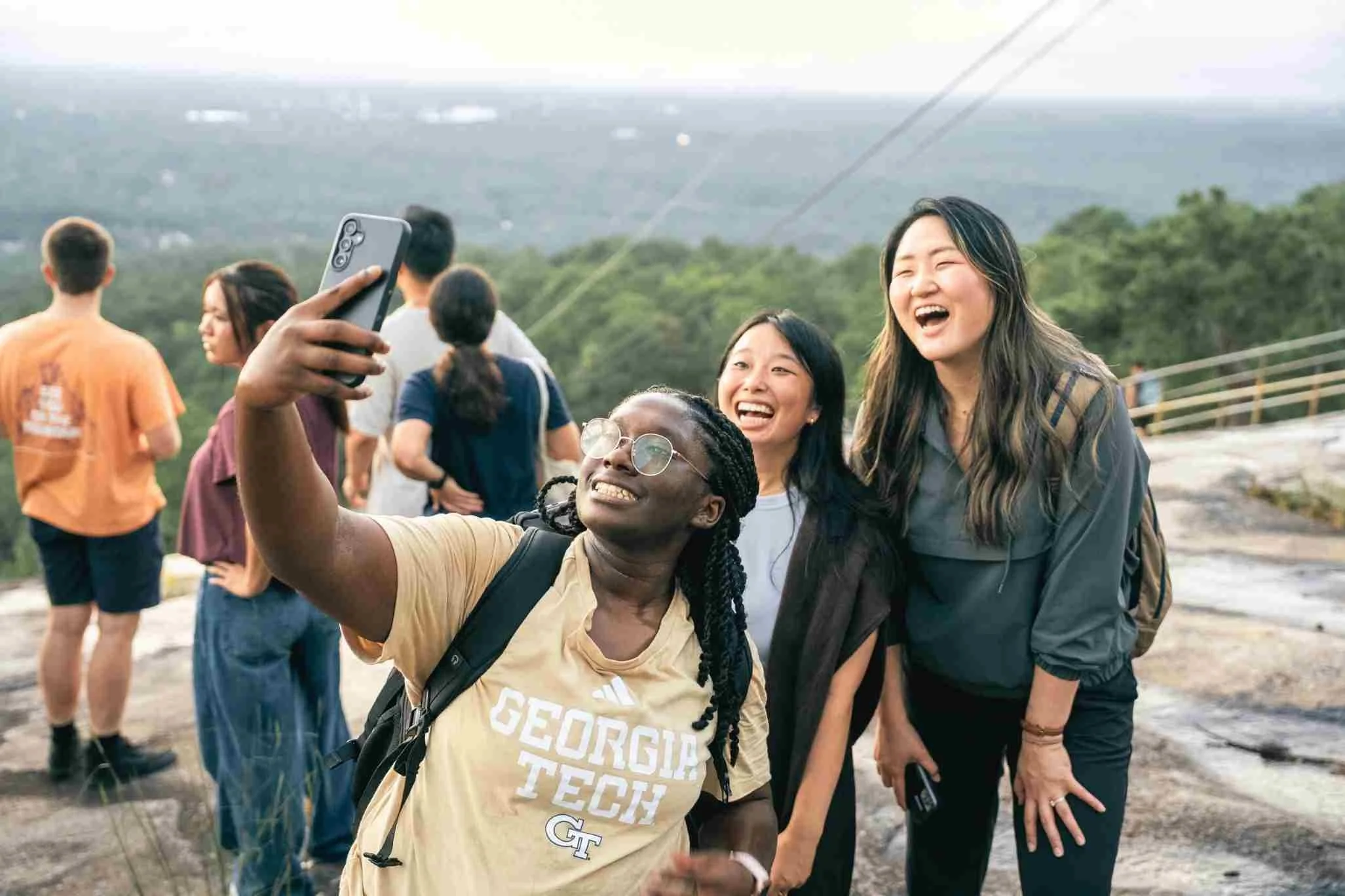 Group of three girls taking a selfie together on top of Stone Mountain