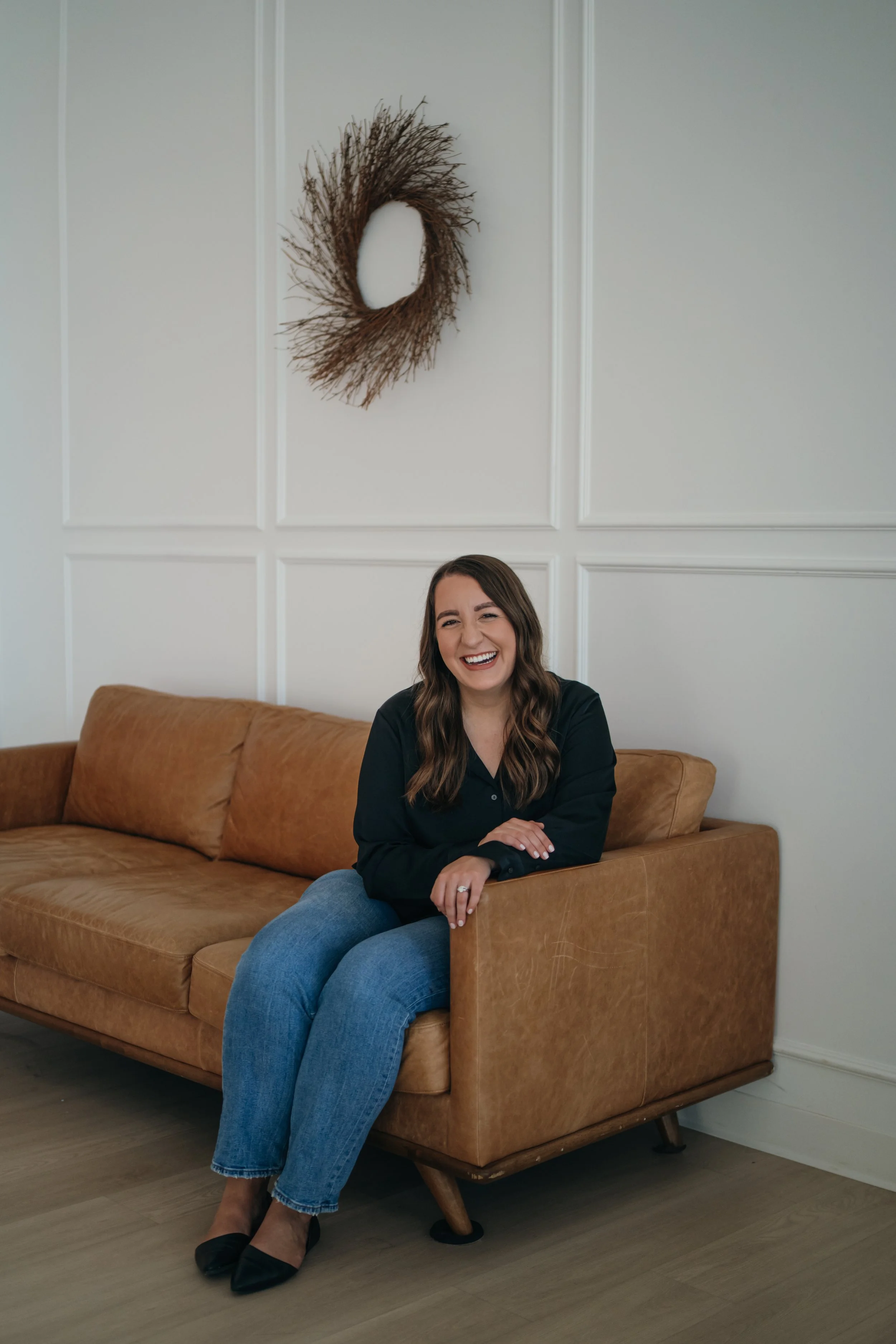 therapist for anxiety, relationship issues, trauma, and burnout smiling in a warm, bright office