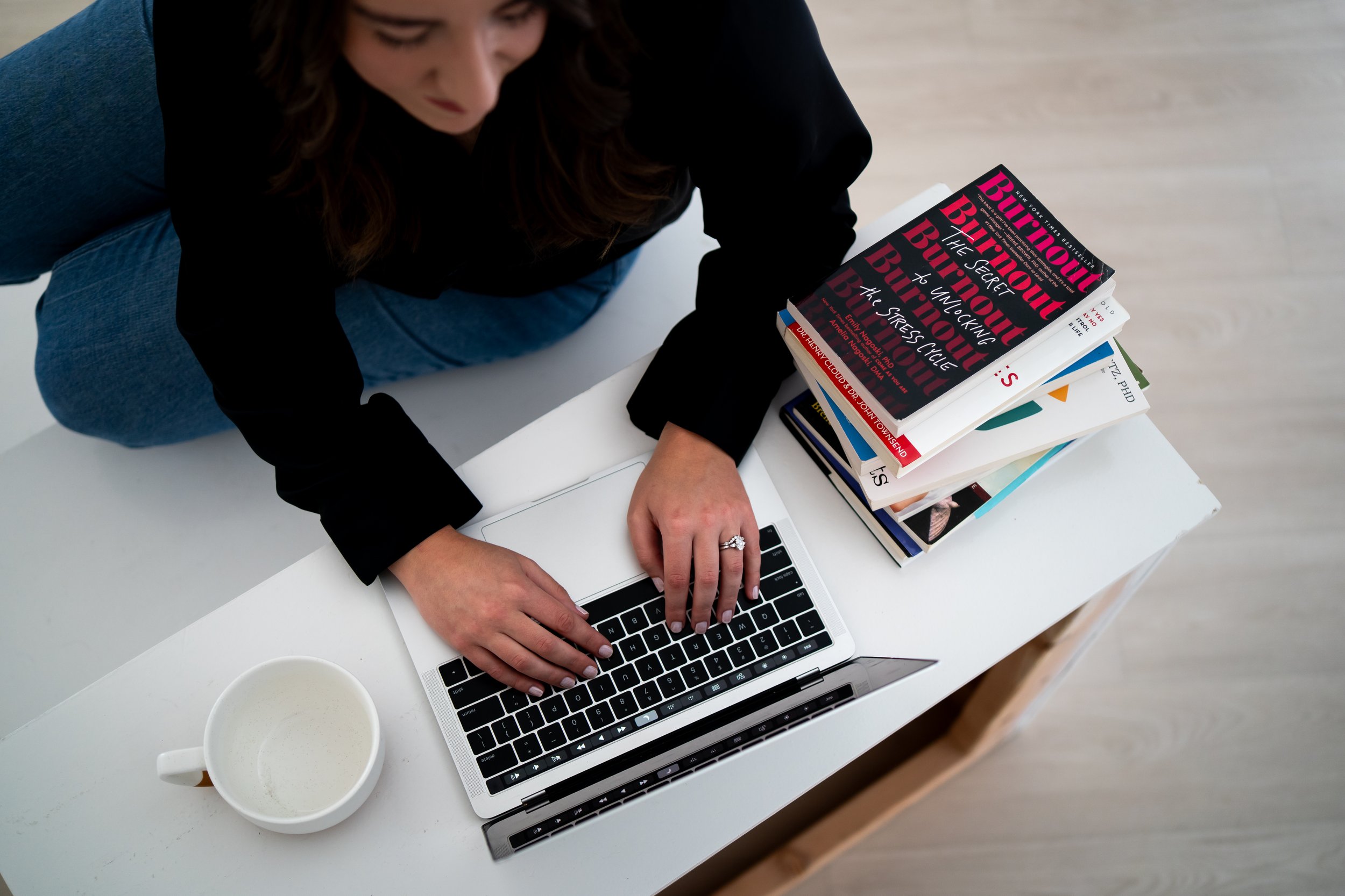 Margaret Cressionnie Heifner, therapist in Southlake, TX, thoughtfully working on her laptop to help teens and adults