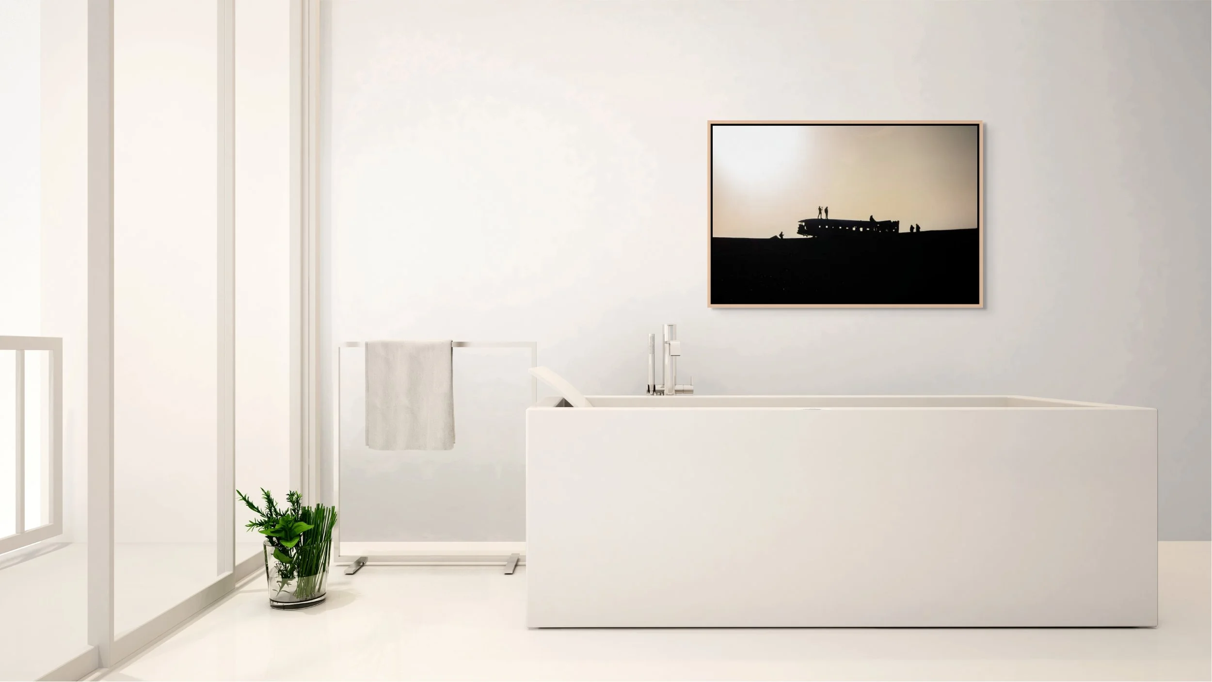 Echoes in the Wreck — DC-3 wreck silhouettes on Iceland’s black-sand plain; framed in natural oak floating wood frame in a minimalist all-white bathroom with a freestanding vanity.