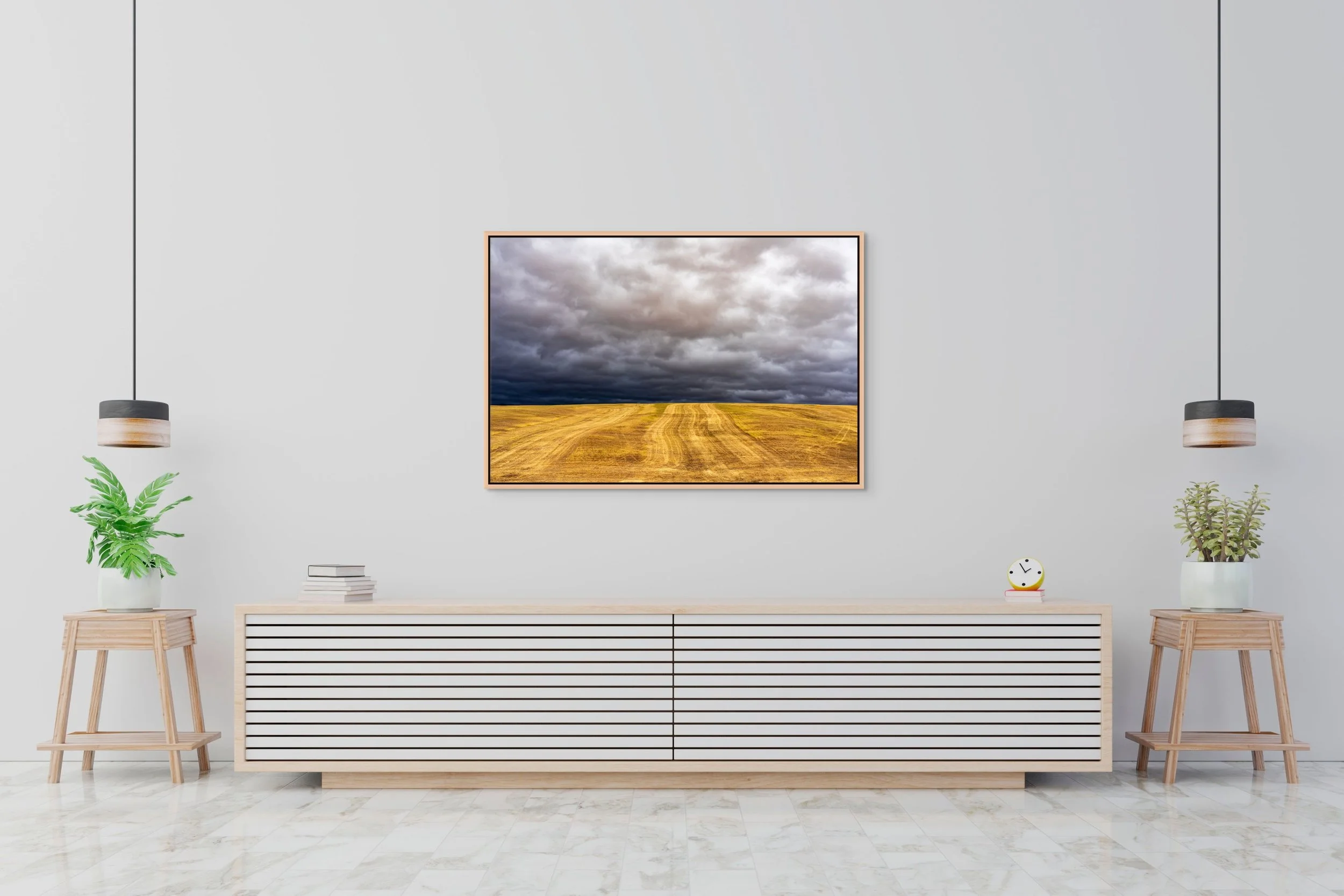 Before the Storm in a floating Natural Oak frame, centered above a long low sideboard in a bright, minimalist space.