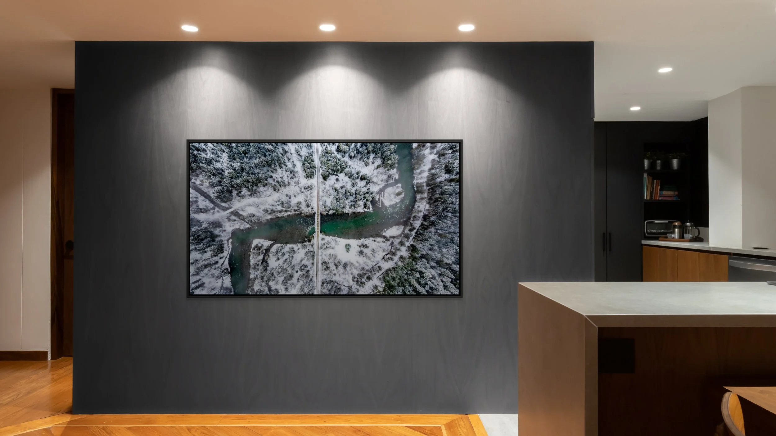 The Hidden Crossing, framed in Black floating frame, mounted on a dark gallery wall under ceiling spotlights.