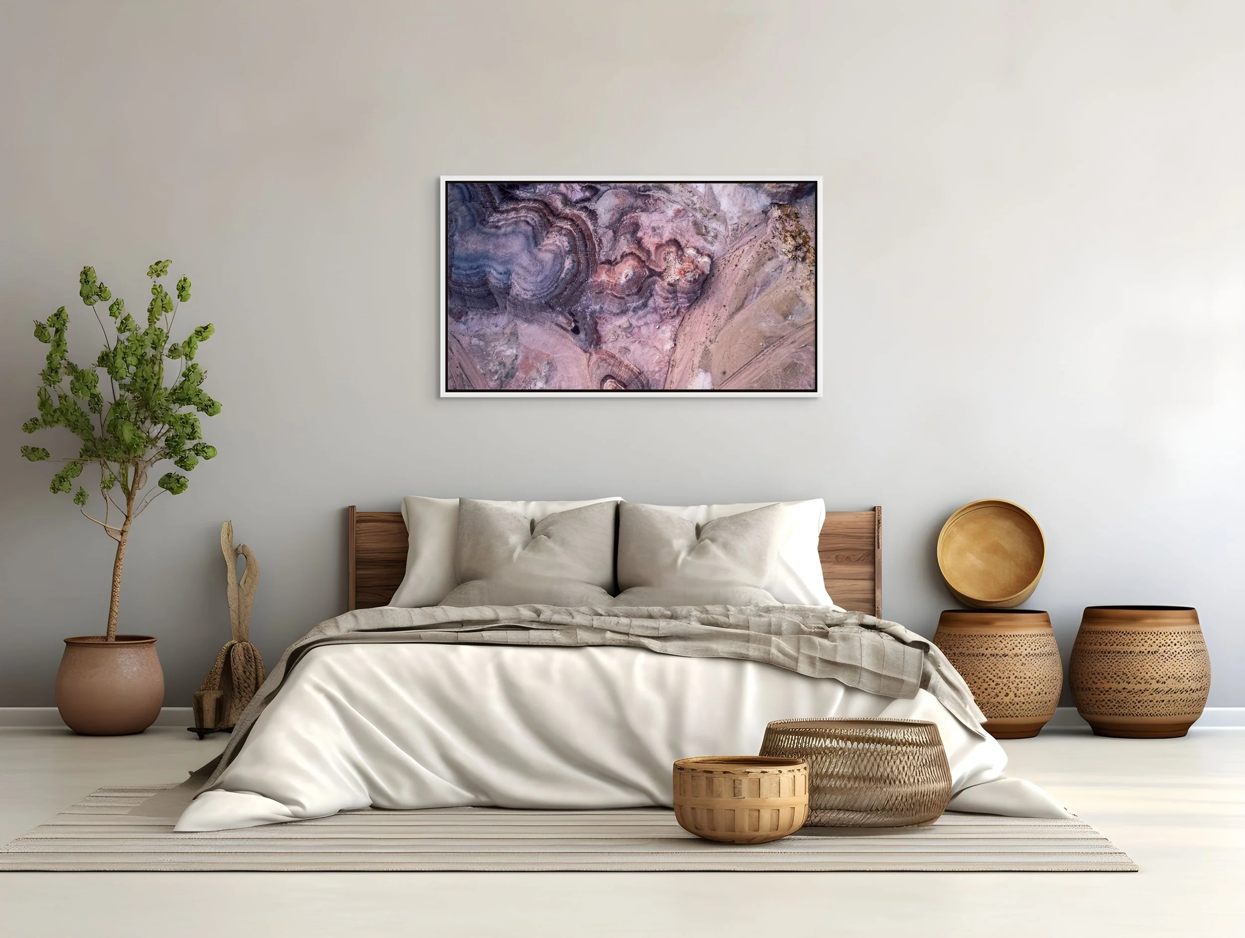 Small in Time — aerial bentonite-hill patterns in mauve and cream, framed in white floating wood frame in a serene neutral bedroom.