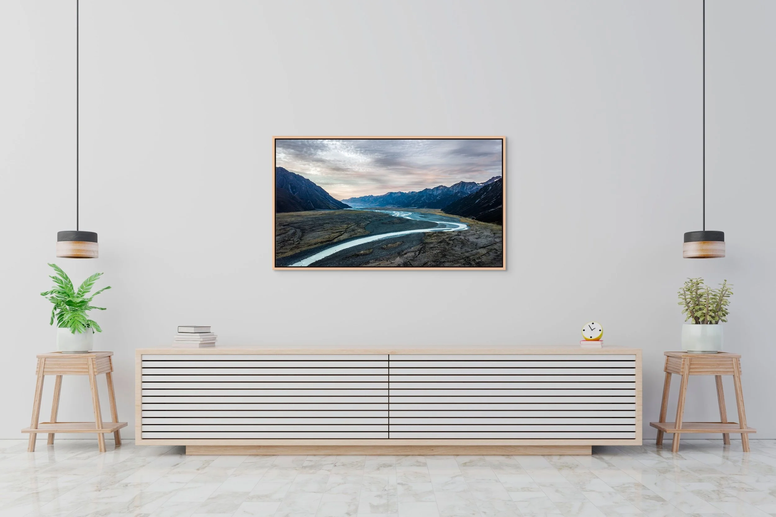 Quiet Between Giants in Oak floating frame above a long white console in a minimalist living room.