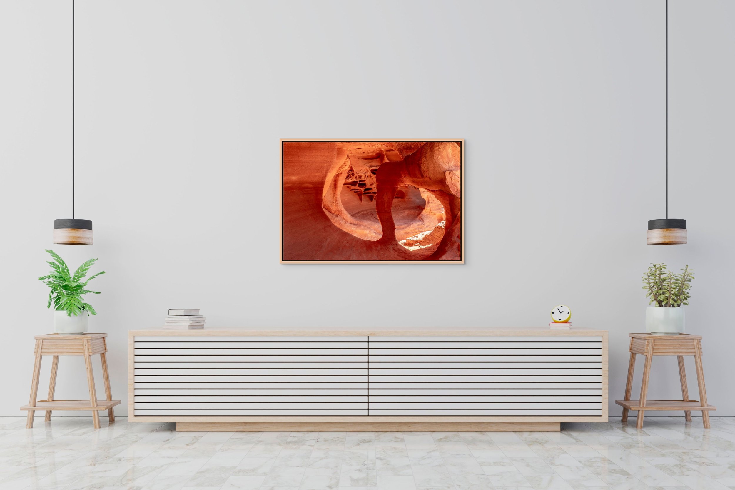 Cathedral of Stone in a floating Natural Oak frame hanging above a low sideboard in a minimalist, bright interior.