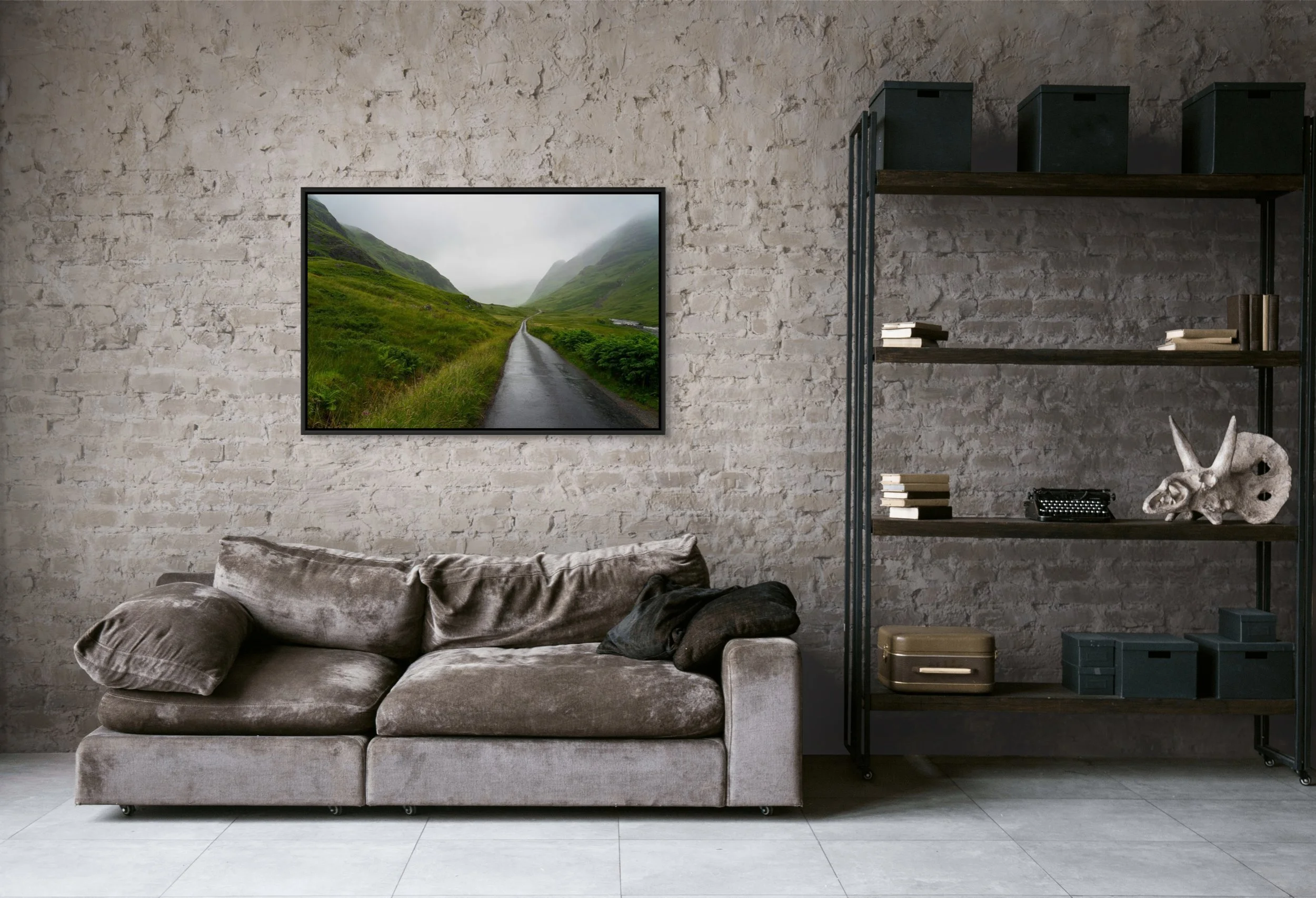 Into the Mist, framed in black, displayed above a grey sectional in a concrete-walled living room.