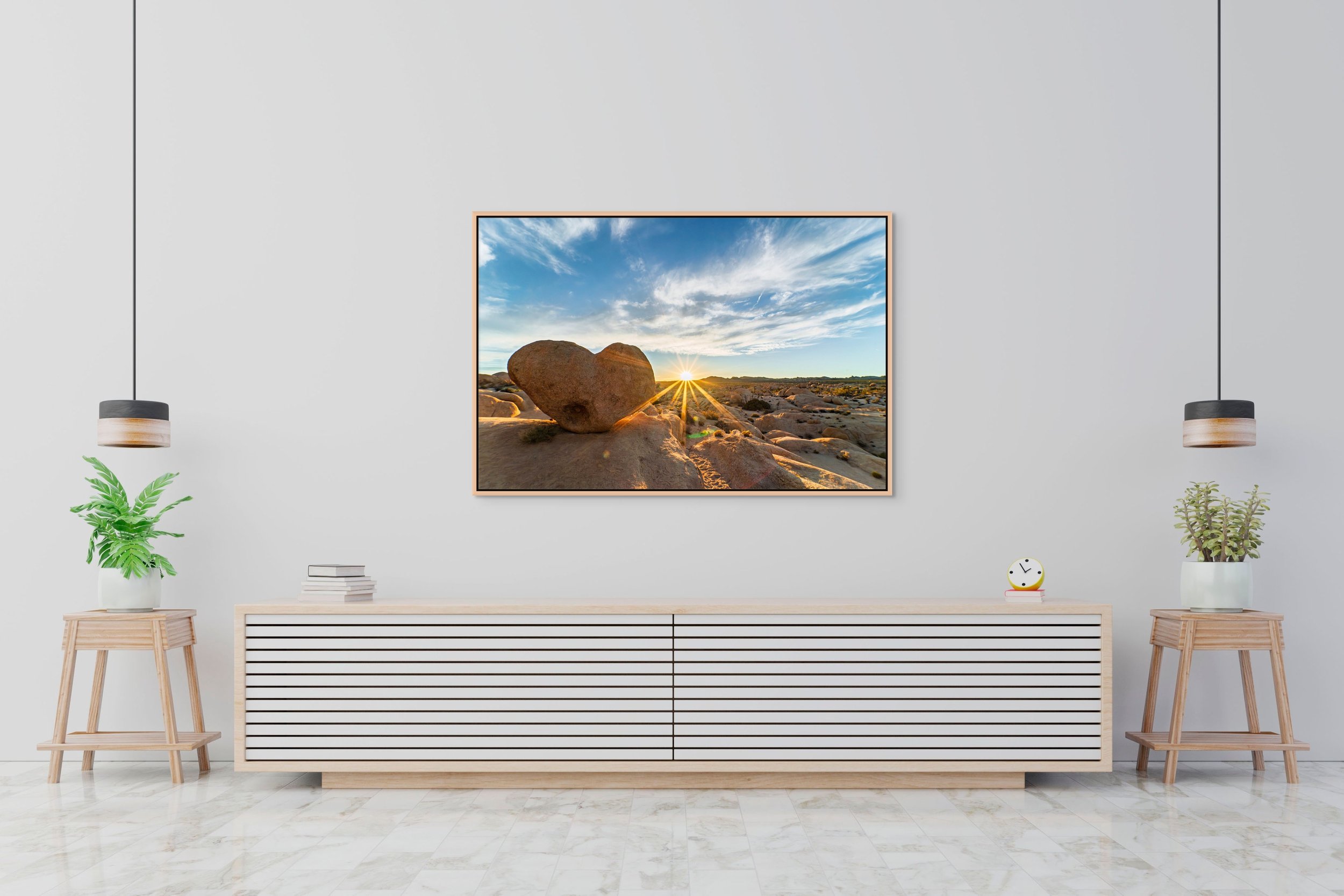 Heart of Gold — heart-shaped boulder at sunset, framed in natural oak floating wood frame on a white credenza wall.