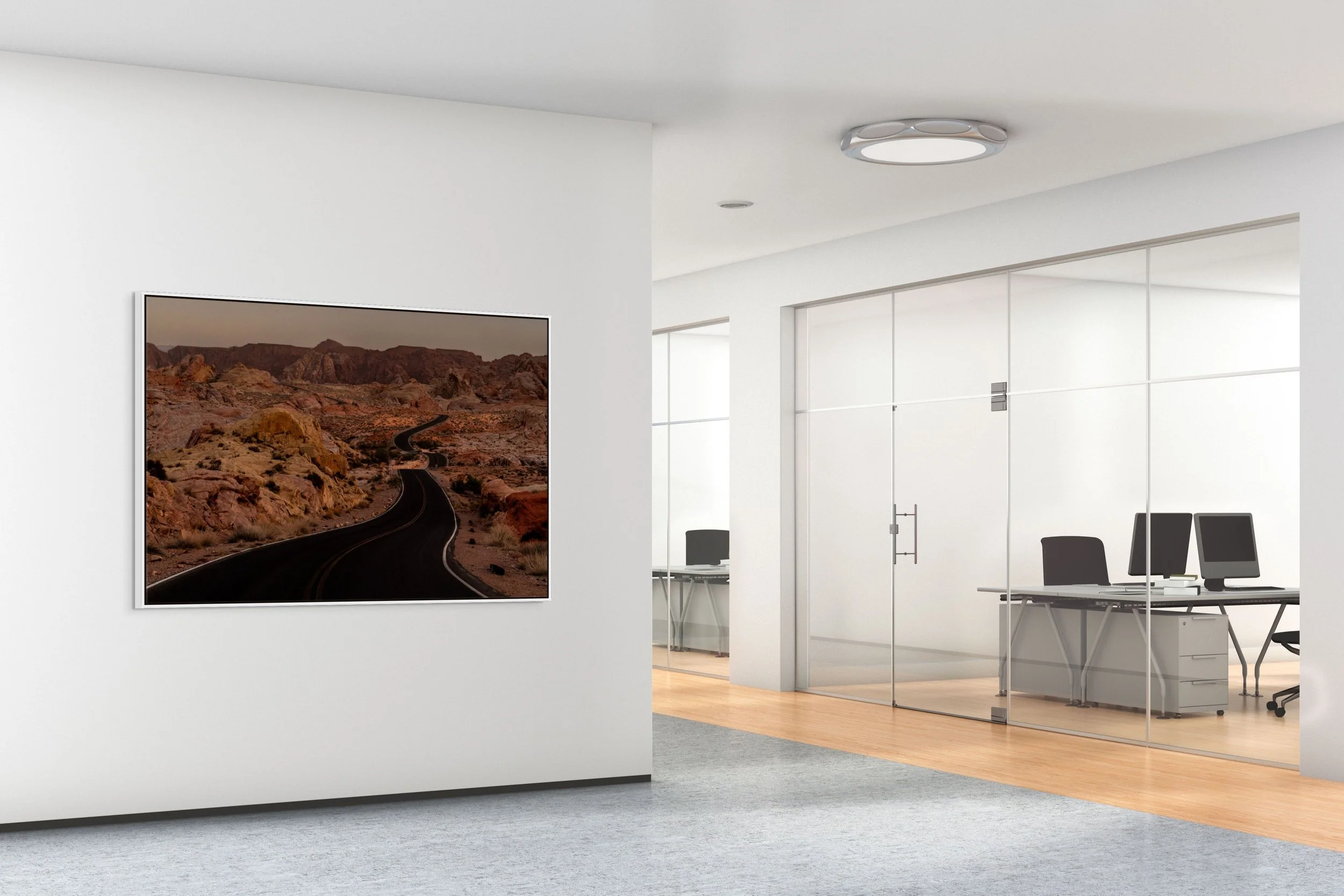 Beyond the Bend — framed in white floating wood frame in a bright modern office corridor with glass walls.
