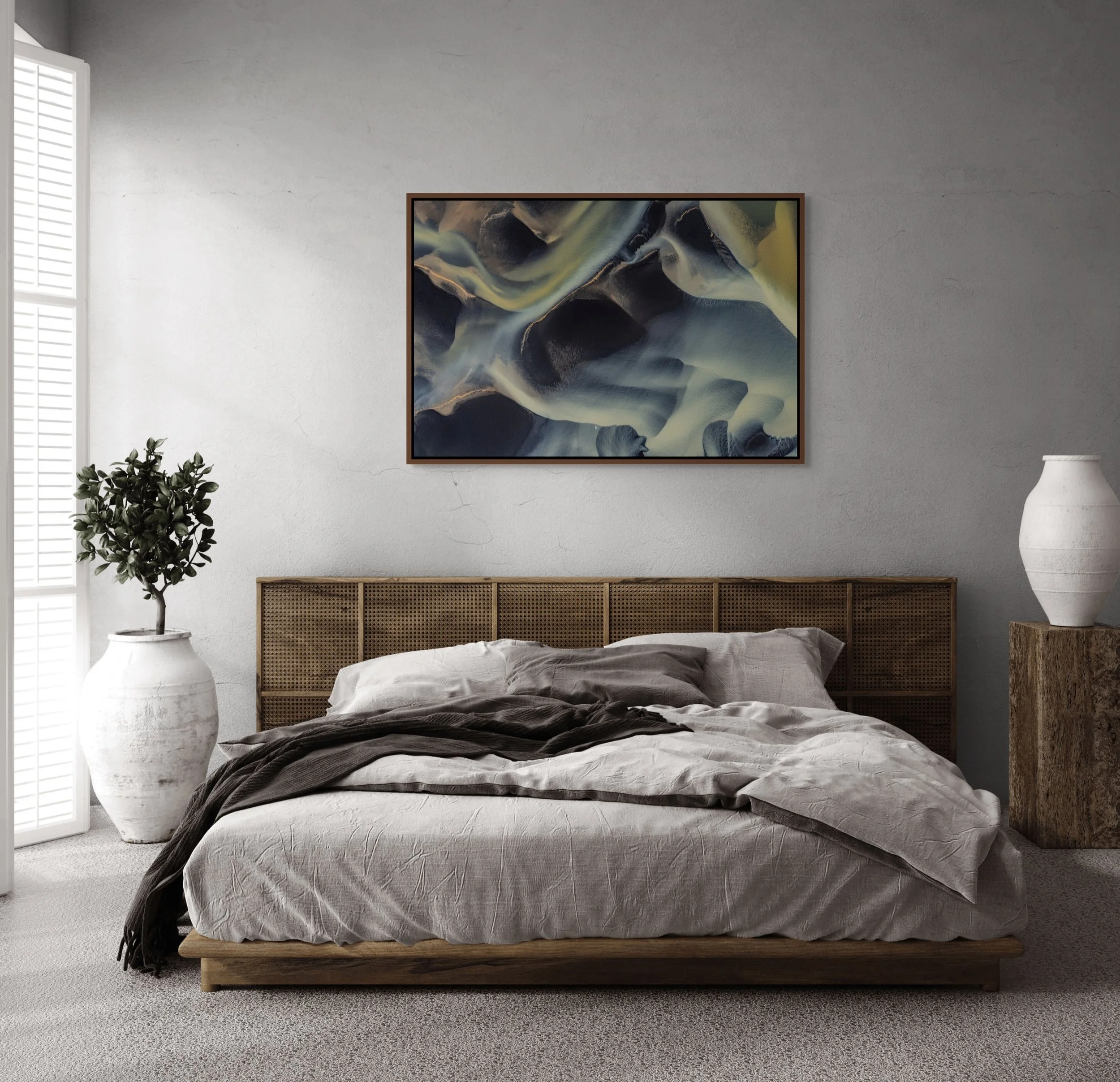 Framed in Alder Brown — River of Shadows above a serene bedroom with neutral bedding and a potted plant.