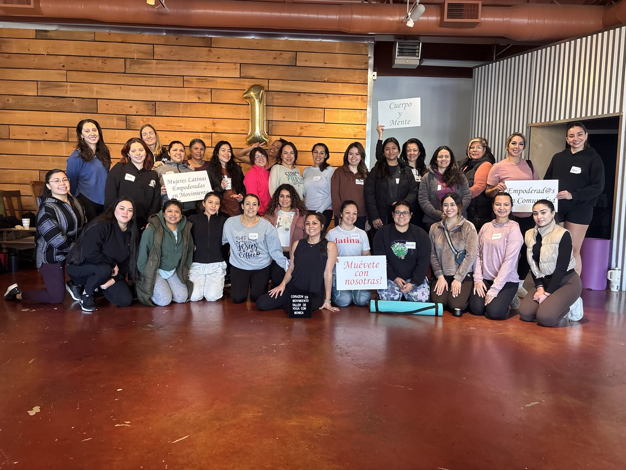 Photo of yoga class in Eugene Oregon in English and Spanish.