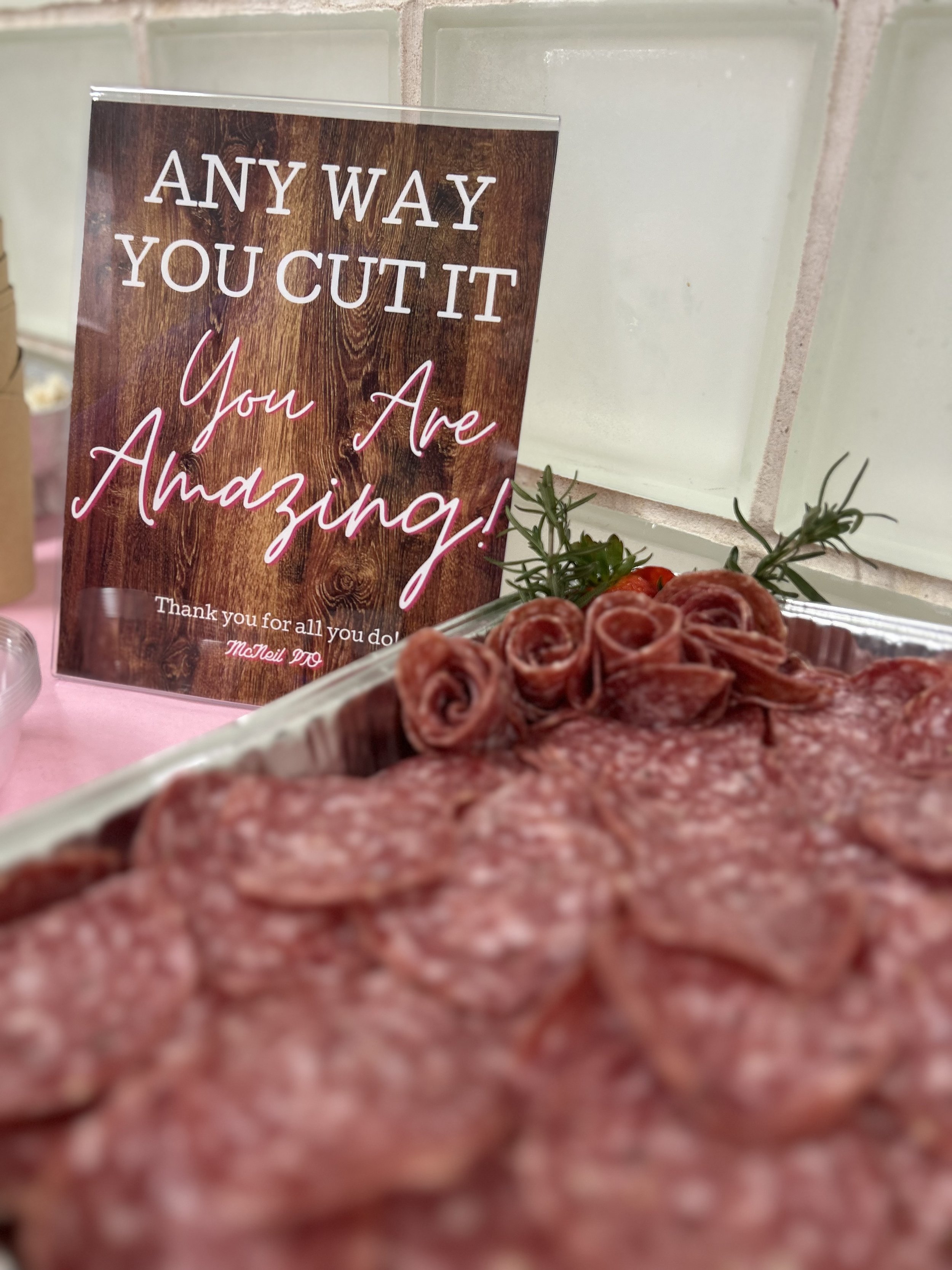 A deli tray with salami for crafting one's own plate.