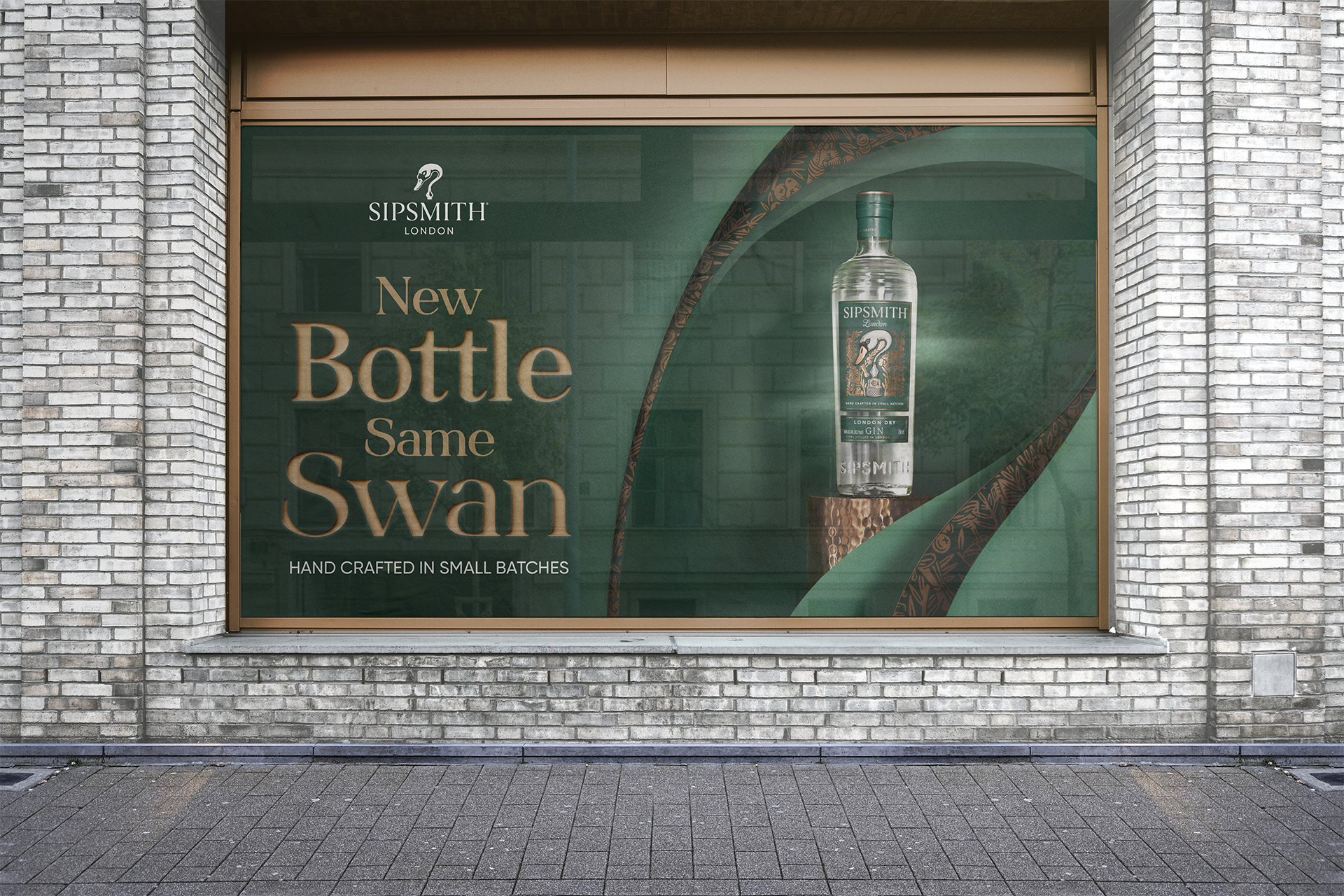 Storefront window advertisement for Sipsmith London gin, featuring a large image of a gin bottle and text that reads: "New Bottle Same Swan" and "Hand crafted in small batches."