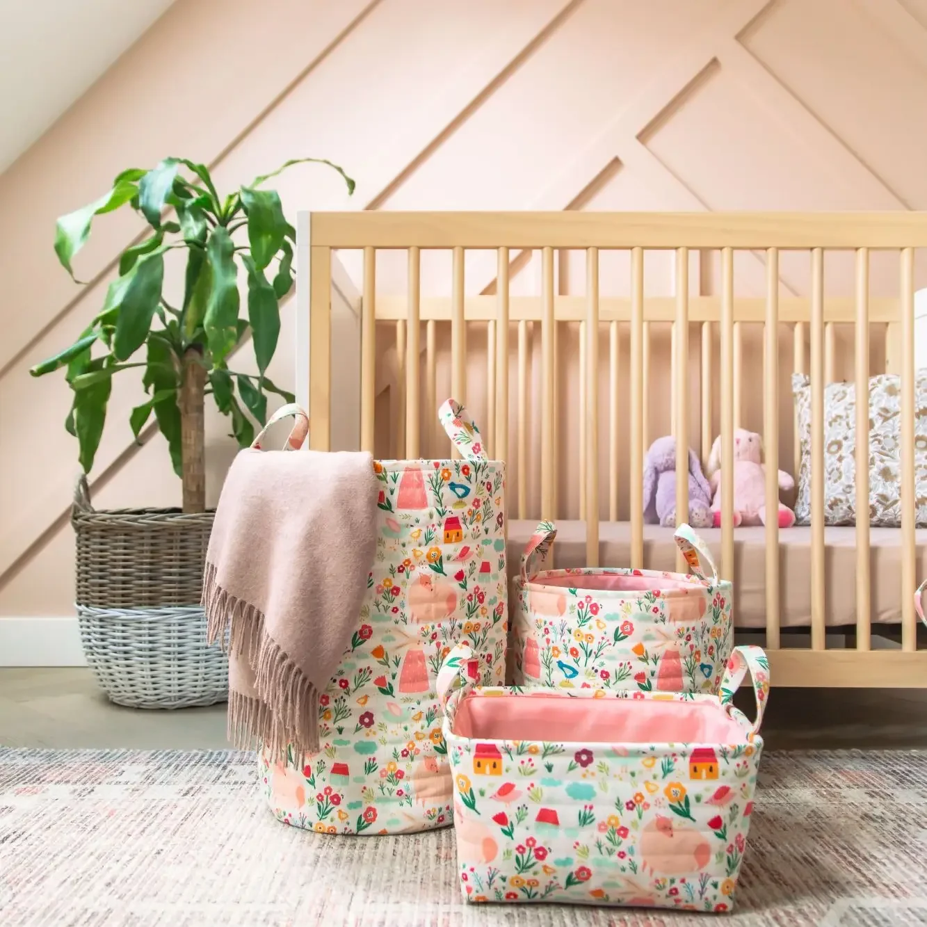 Nursery with a wooden crib, potted plant, and colorful storage baskets.