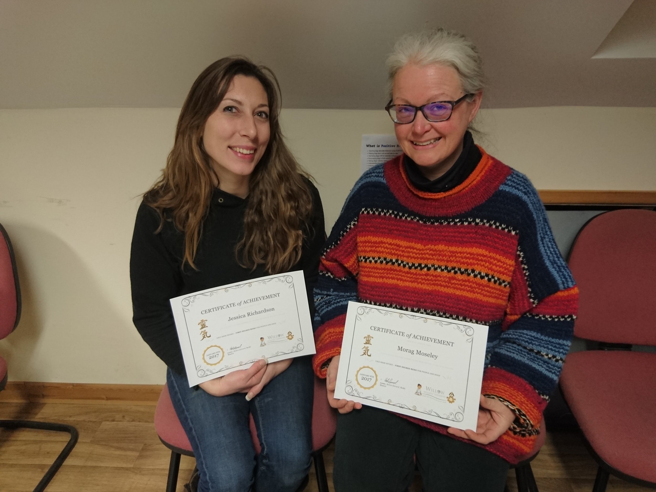 Two students with their Reiki certificates