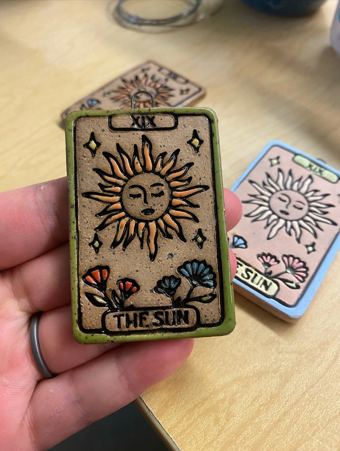 The Sun☀️I designed my version of the card in illustrator and then 3d printed it as a cookie cutter. Stamped it into the clay and used Stroke n Coat to glaze it. I also made some of them with a nichrome wire hook so they can hang as an ornament. 

Th