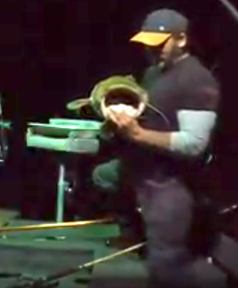 Fishing Guide Dustin Schmidt of Lake Weiss Destinations holding a large mouth Bass fish he caught  on a boat on Coosa River Alabama on Georgia border at Weiss Lake