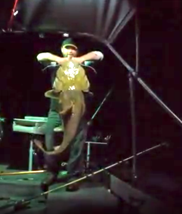 Fishing Guide Dustin Schmidt of Lake Weiss Destinations holding a large catfish during night fishing trip on Coosa River Alabama on Georgia border at Weiss Lake