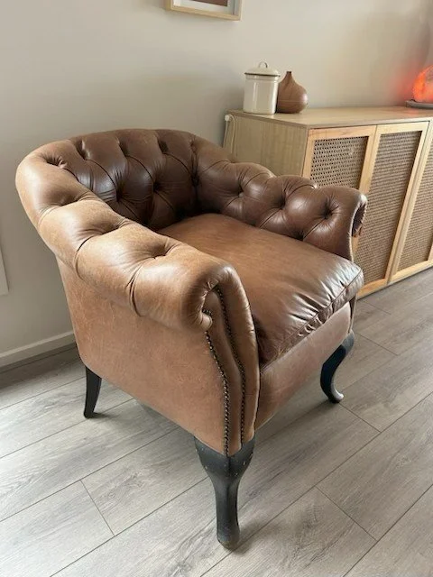 Traditional brown leather  armchair with 'buttoning'. Recovered by John of JB's upholstery specialist