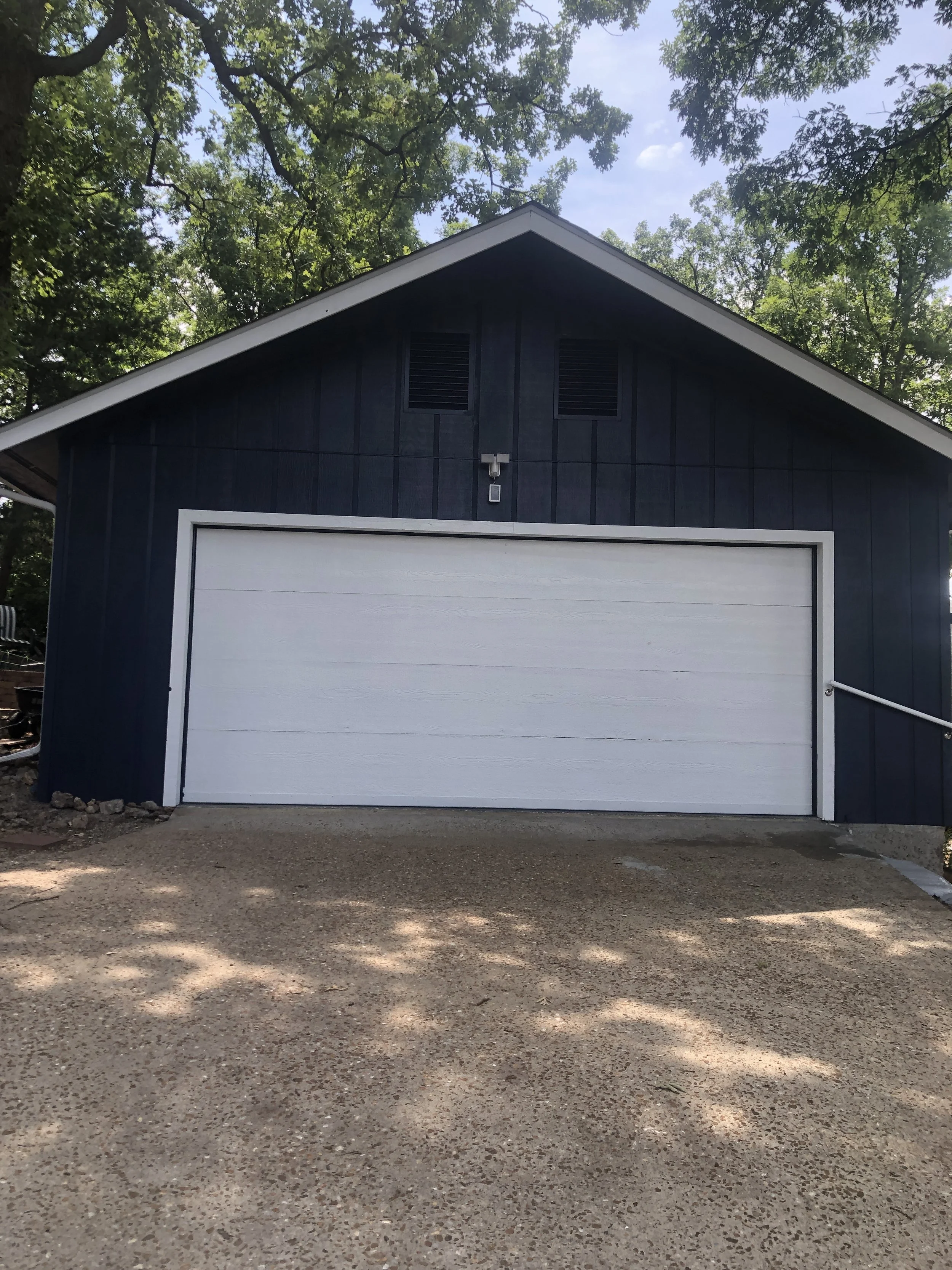 High-contrast white trim and siding painted to match house trim and siding by Quality Control Painting in Osage Beach.