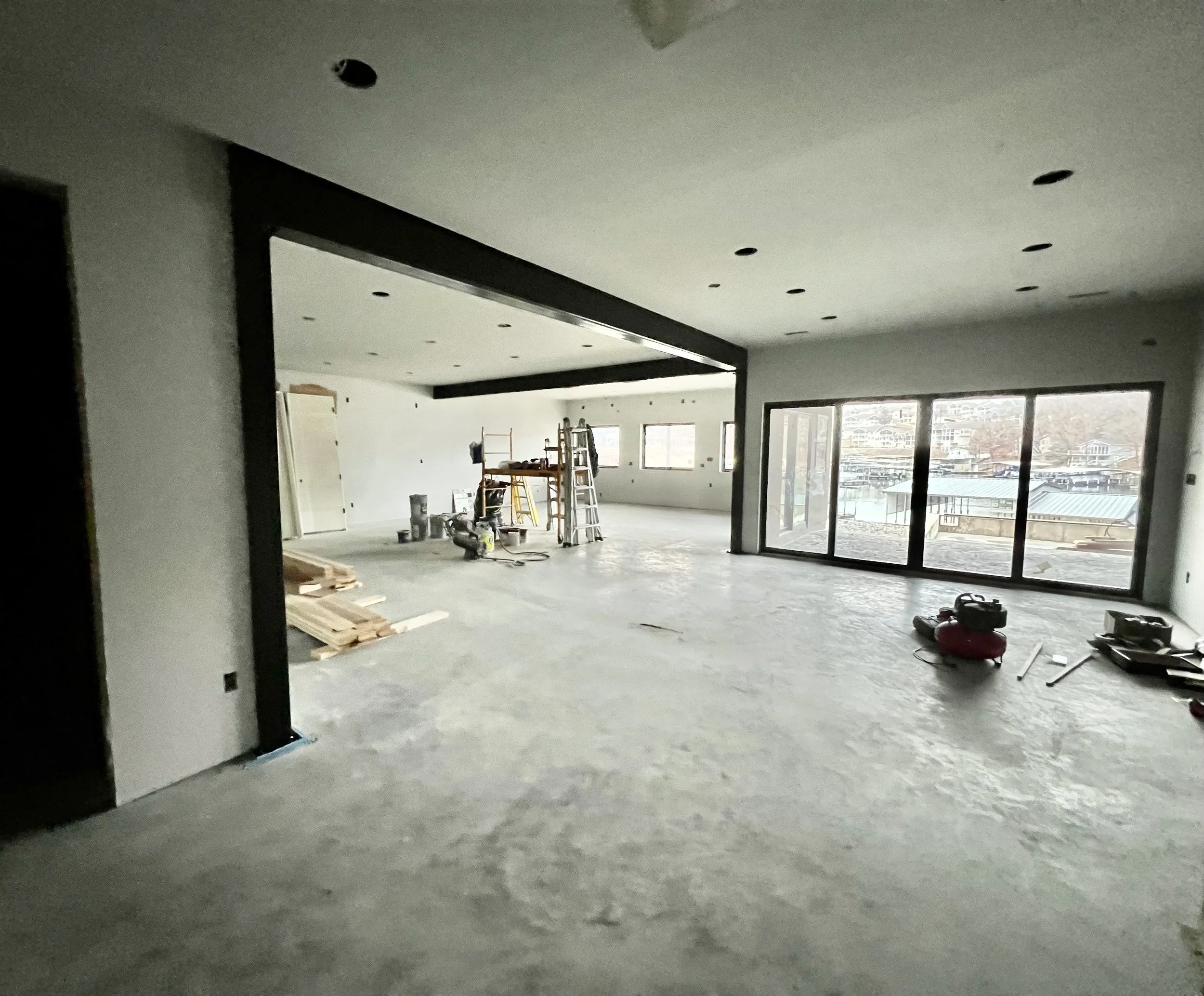 Large open-concept lake home in Linn Creek featuring black beam painting and interior finishing by Quality Control Painting.