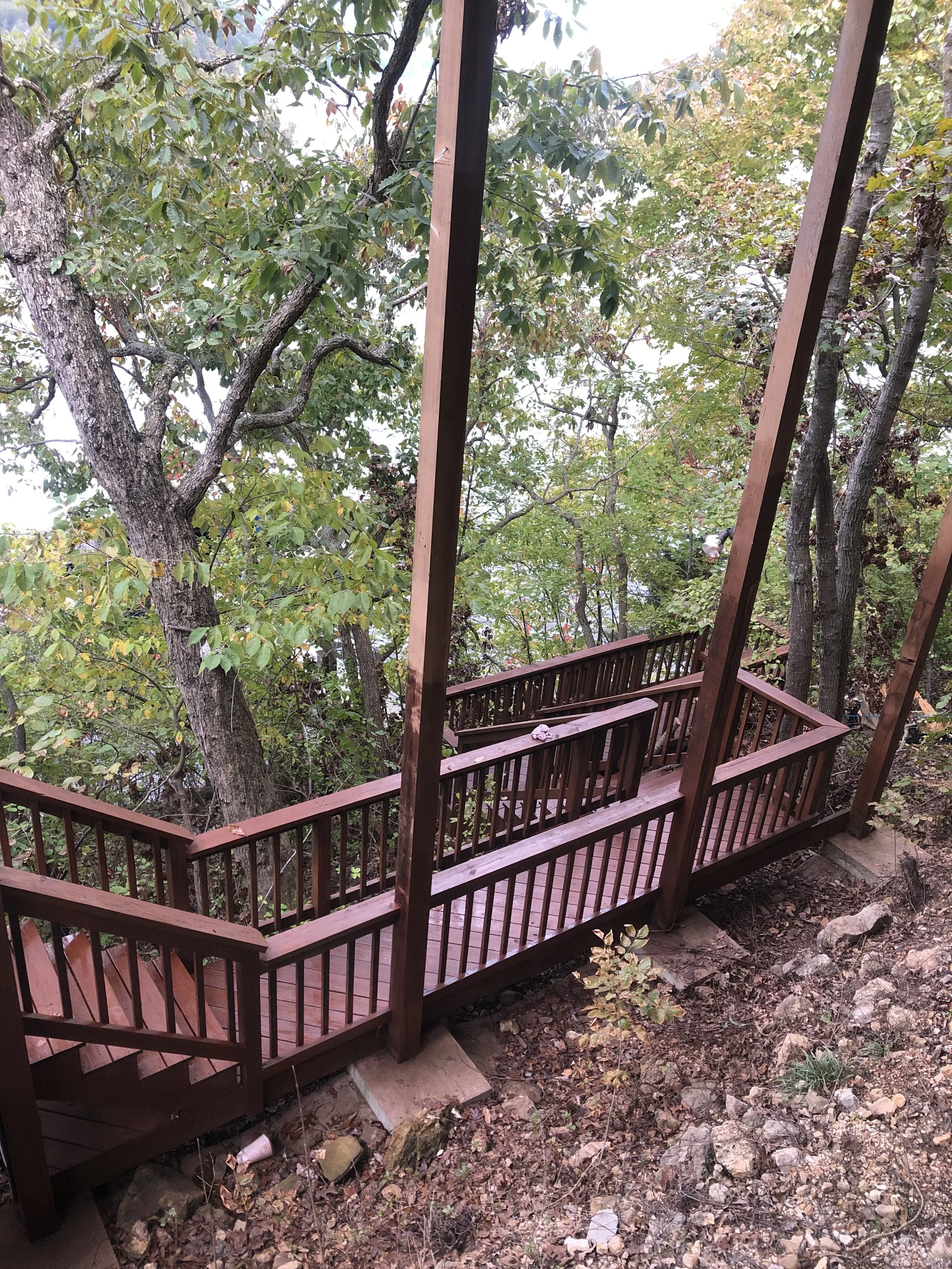 Professional painting of deck railings and pillars on a steep lakefront lot by Quality Control Painting in Lake Ozark.