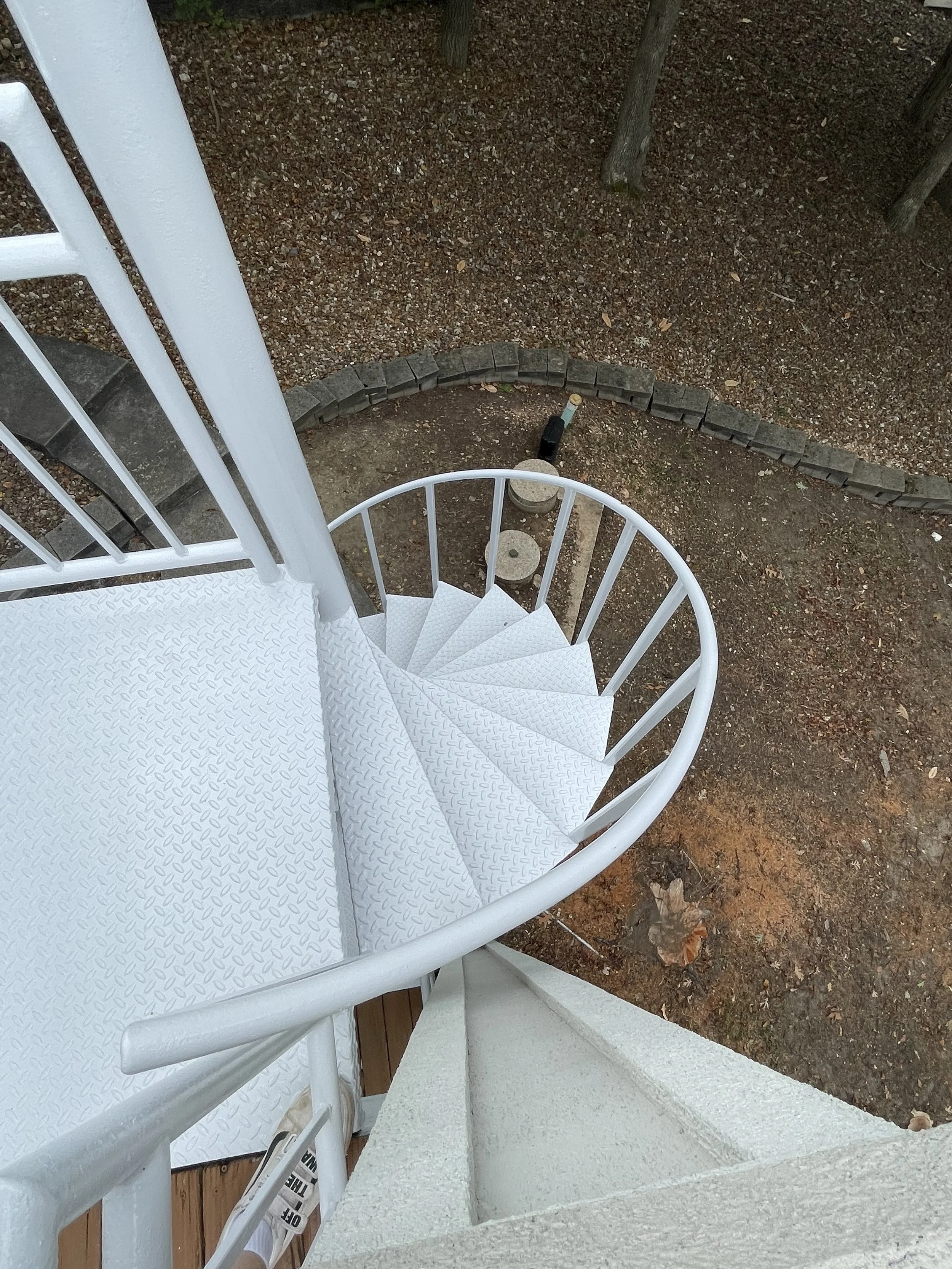 Black metal spiral staircase and multi-level spiral deck painted by Quality Control Painting in Lake Ozark.