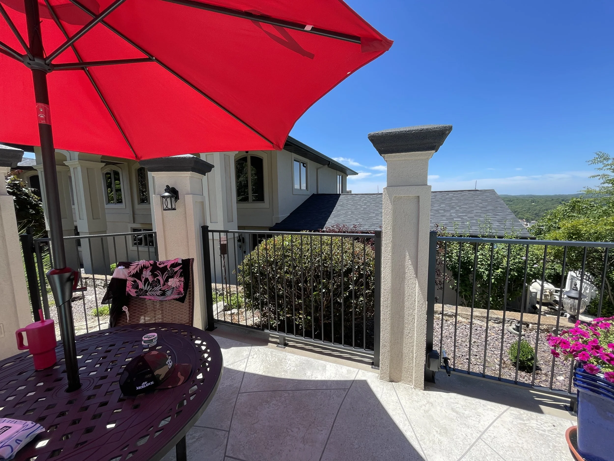 Architectural pillar and railing painting for an outdoor area in Osage Beach by Quality Control Painting.