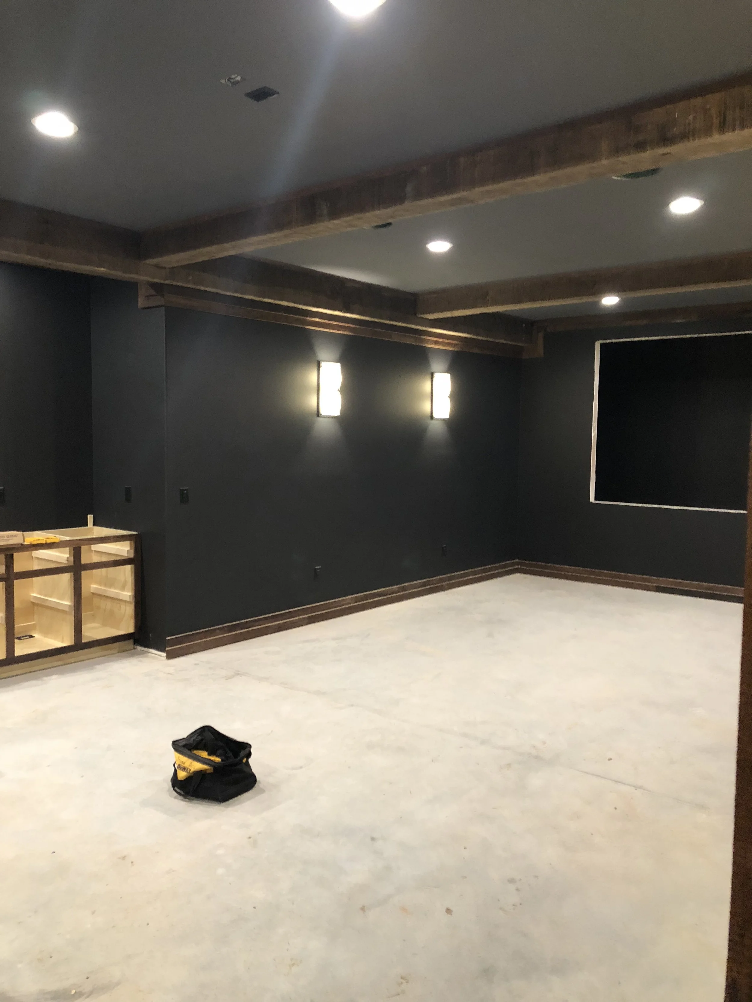 Professional charcoal gray wall painting in a custom home theater by Quality Control Painting in Osage Beach.