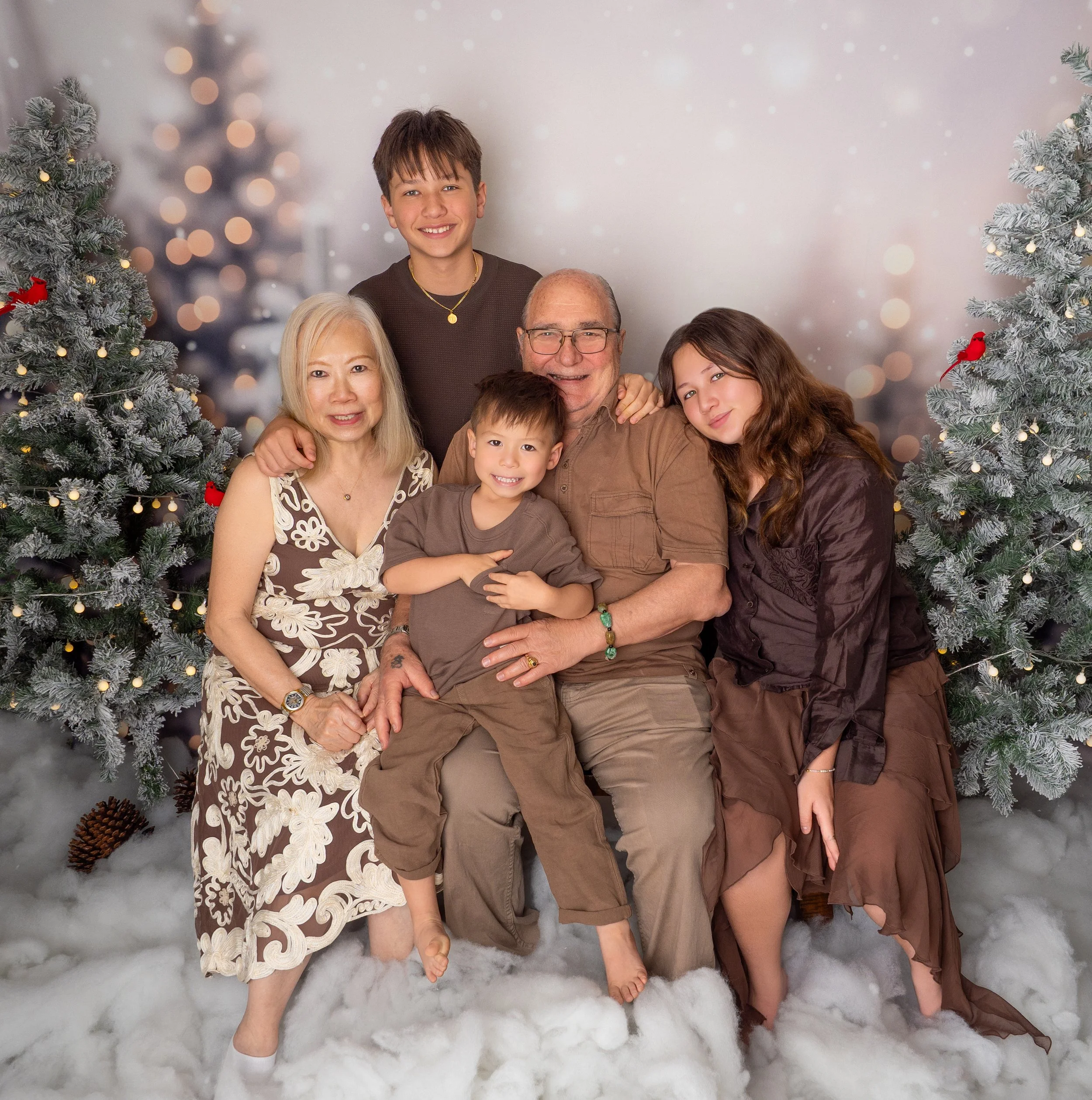 Grandparents and grandchildren together in a snowy Christmas family photography session