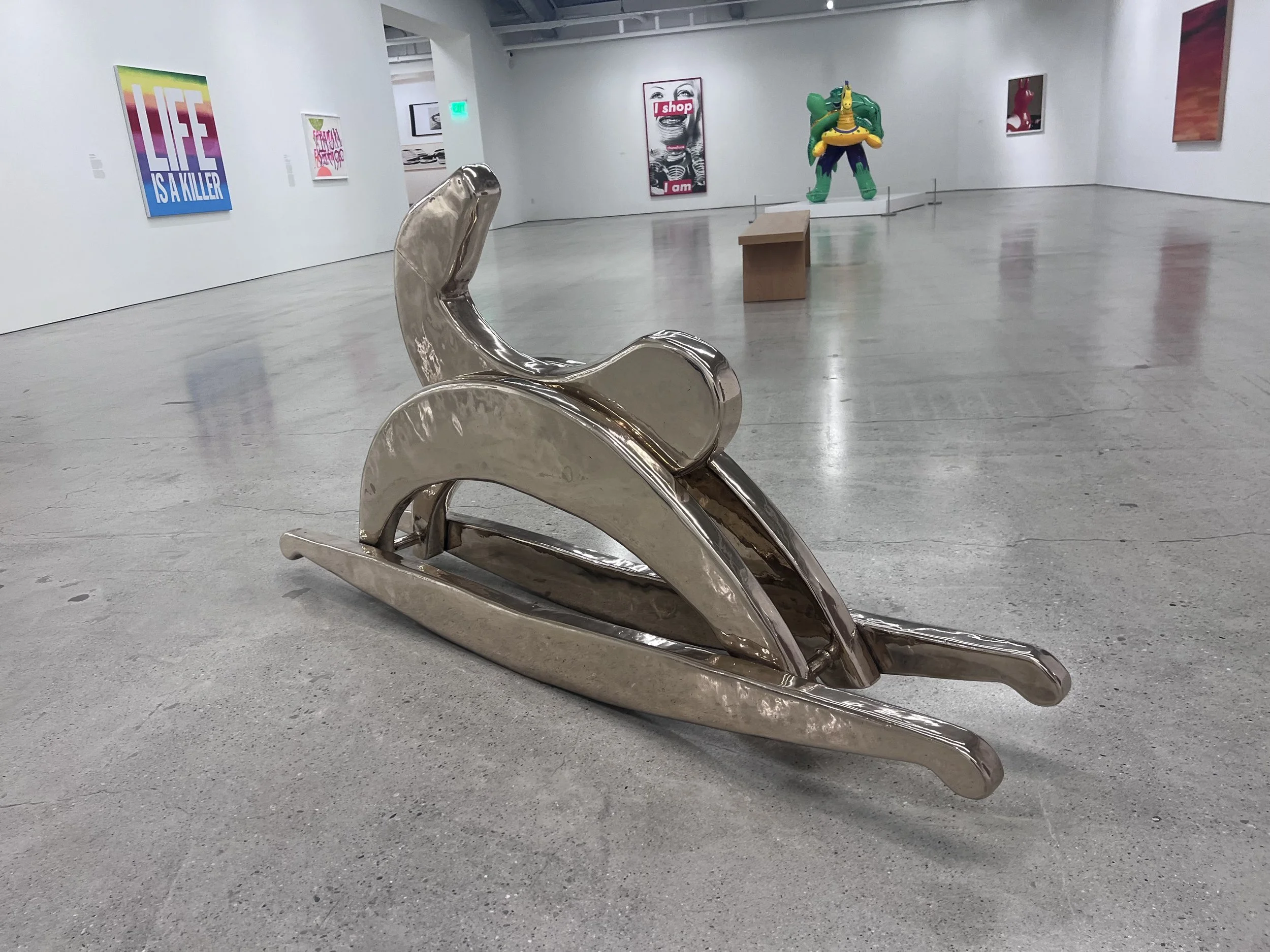 Sherry levine sculpture of a high polished bronze horse after conservation cleaning in a gallery space. 