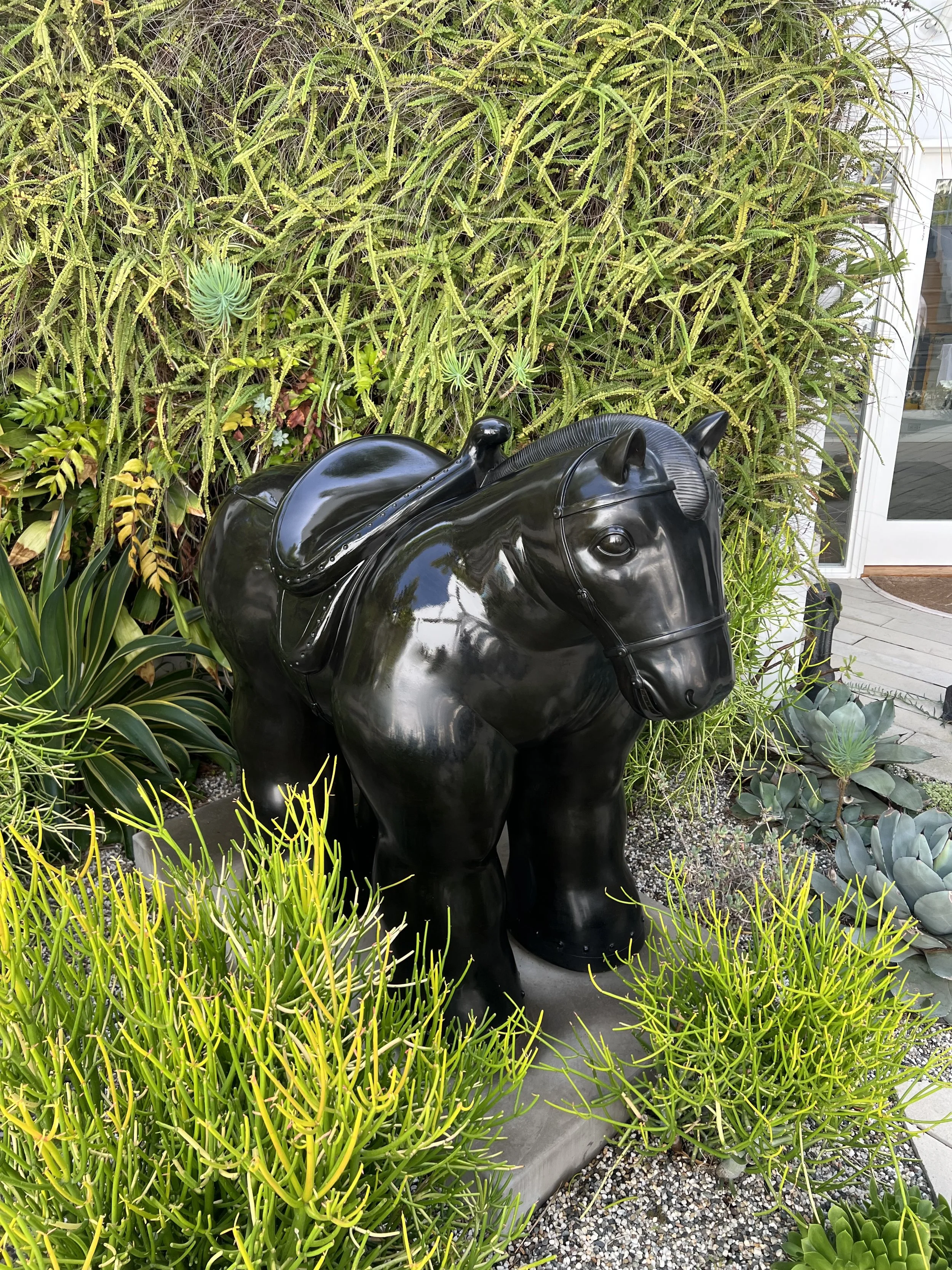 Botero bronze horse after hot wax sculpture maintenance. It has been waxed, torched, and buffed.