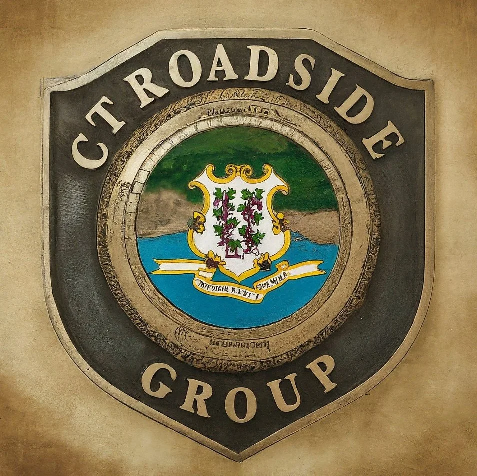 A shield-shaped sign with the words 'CT Roadsides Group' surrounding a central emblem featuring a coat of arms with a landscape, water, and vines.