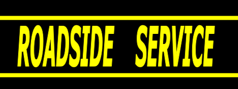 Roadside service sign with yellow text on a black background reading 'ROADSIDE SERVICE'.