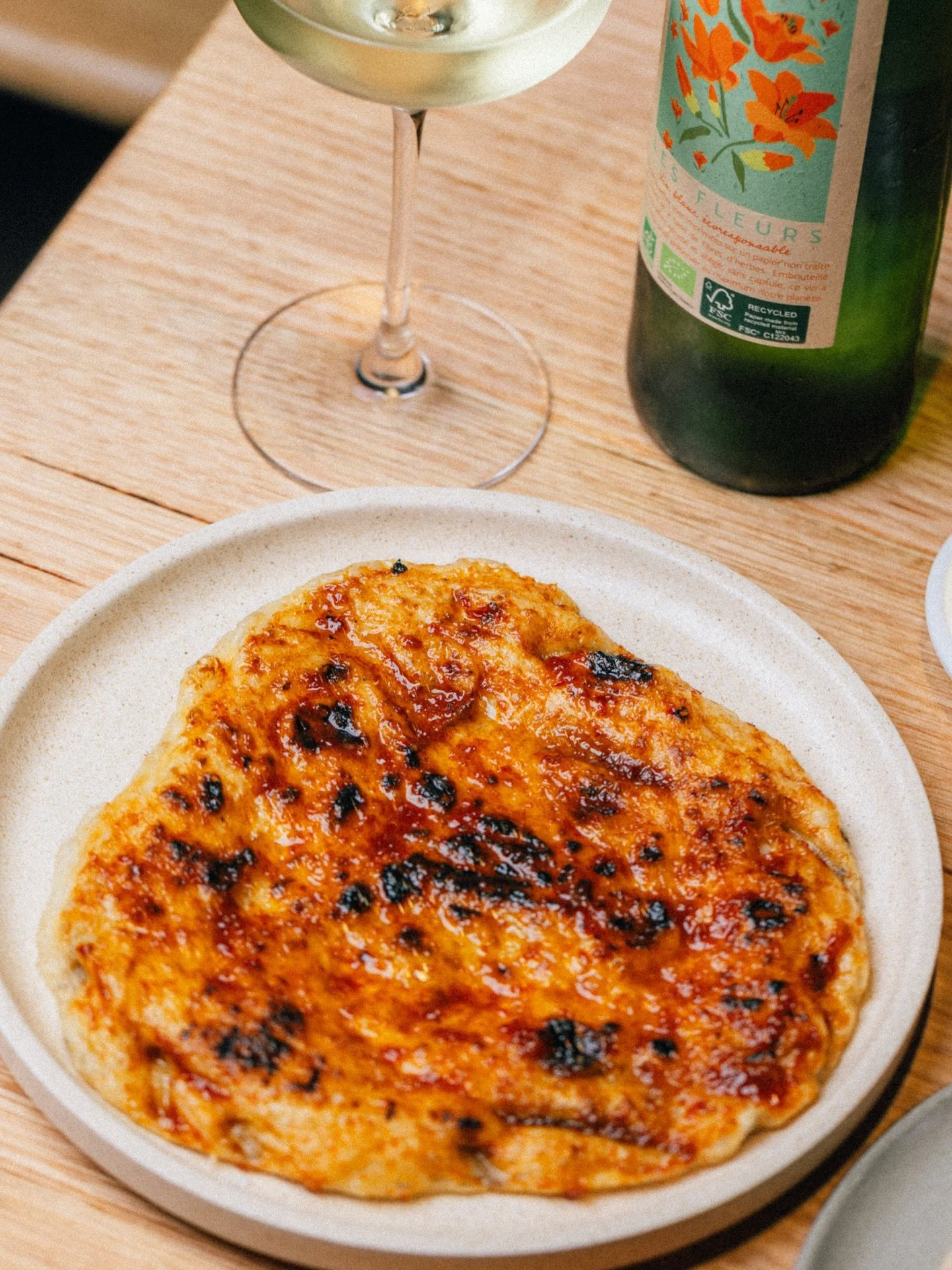 We&rsquo;re super keen to roll out our new summer dishes in the coming weeks. This wood-fired charcoal flatbread, finished with a tamarind&ndash;red chilli glaze and served with roasted garlic and coriander butter, is made for tearing in with your ha