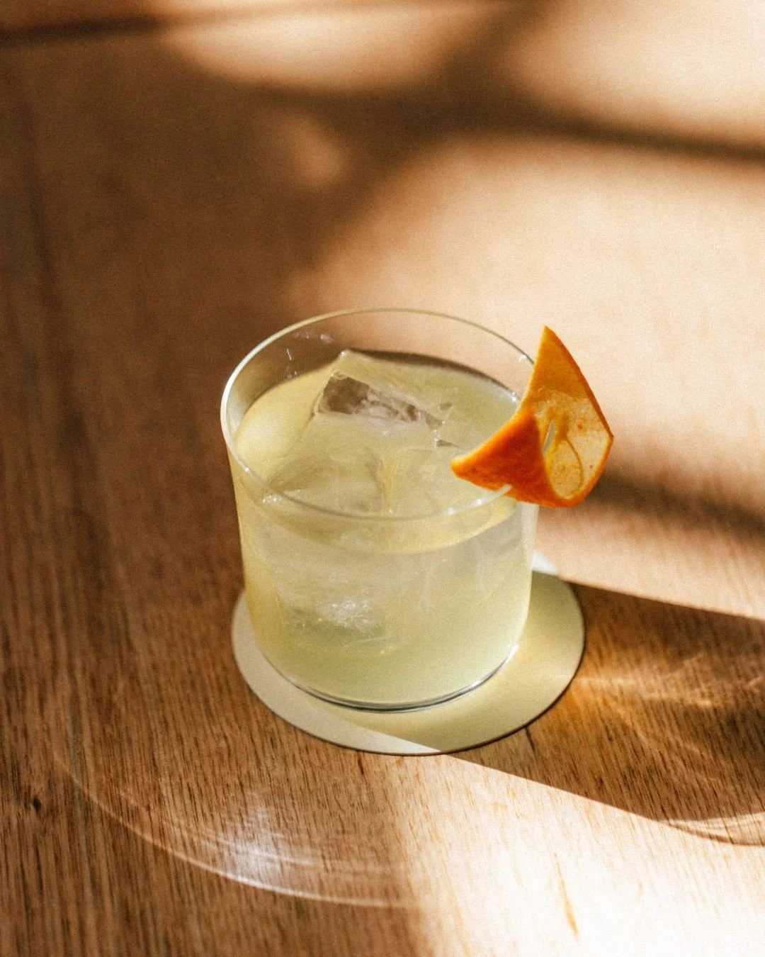 At peak season, we tuck chinotto into sugar and let time do the work. After a month, its flavours infuse into gin, becoming the base of our Chinotto Spritz.