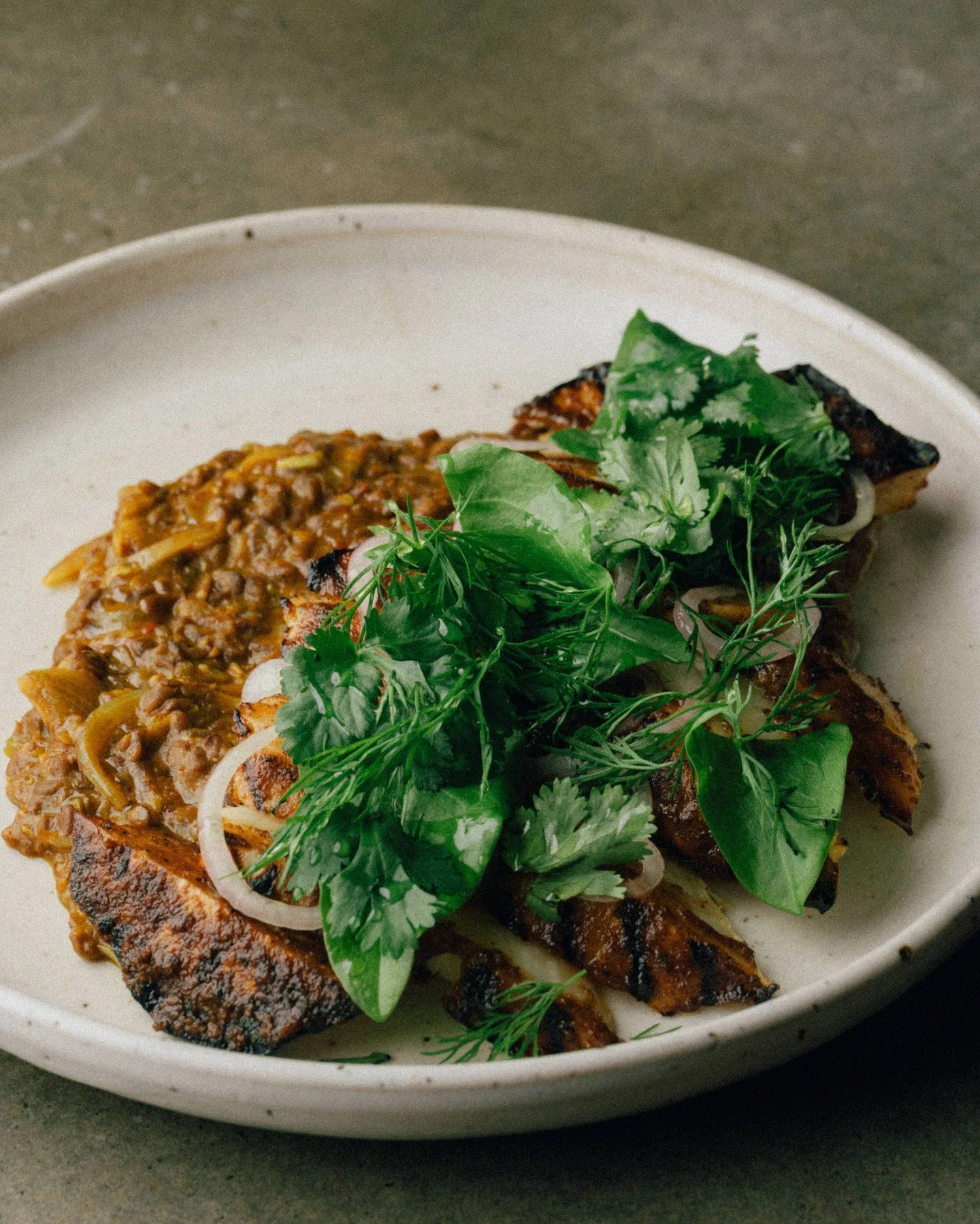 Grilled masala celeriac, Mt. Zero dal bhorta

The star of this dish is the dal bhorta, which means mashed lentils. Traditionally, dal bhorta is served quite dry, but we prepare our @mountzero Persian lentils quite loose with mustard oil, onion, garli