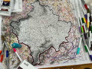 Map of Poland surrounded by colored pens and markers on a desk.