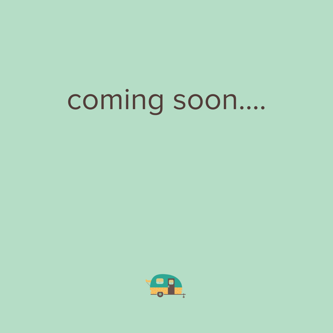 A light green background with the text 'coming soon....' in the center and a small illustration of a camper trailer at the bottom.