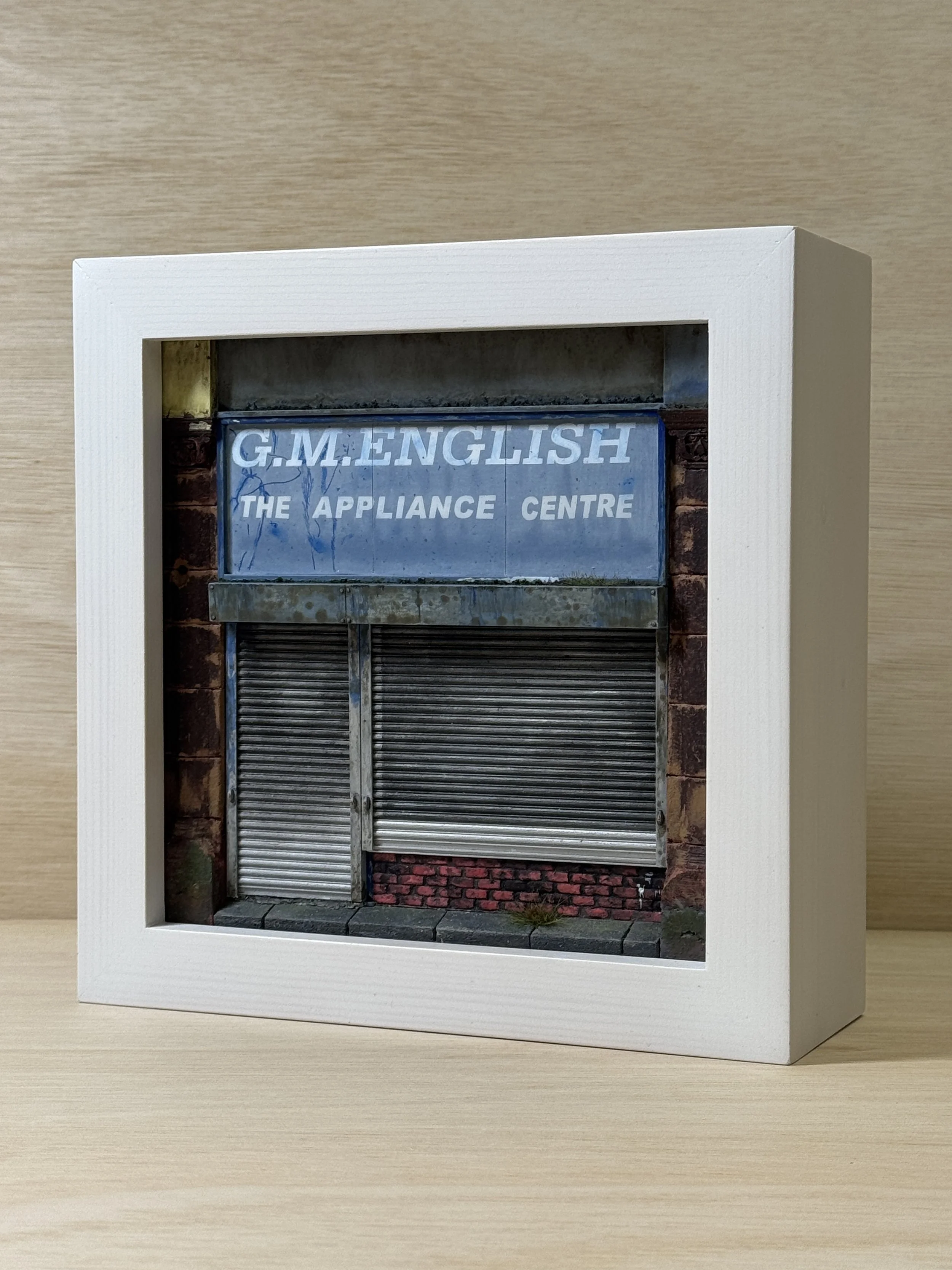 G.M. English shop front facade in frame. 1:24 scale.
