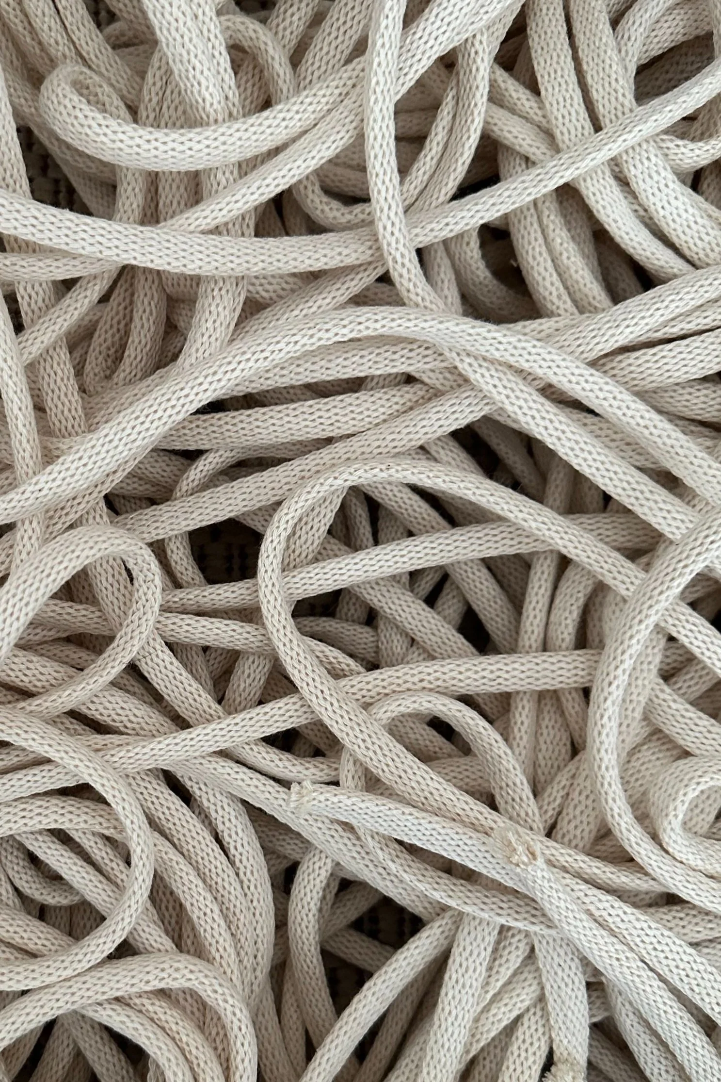 Close-up of tangled white shoelaces.