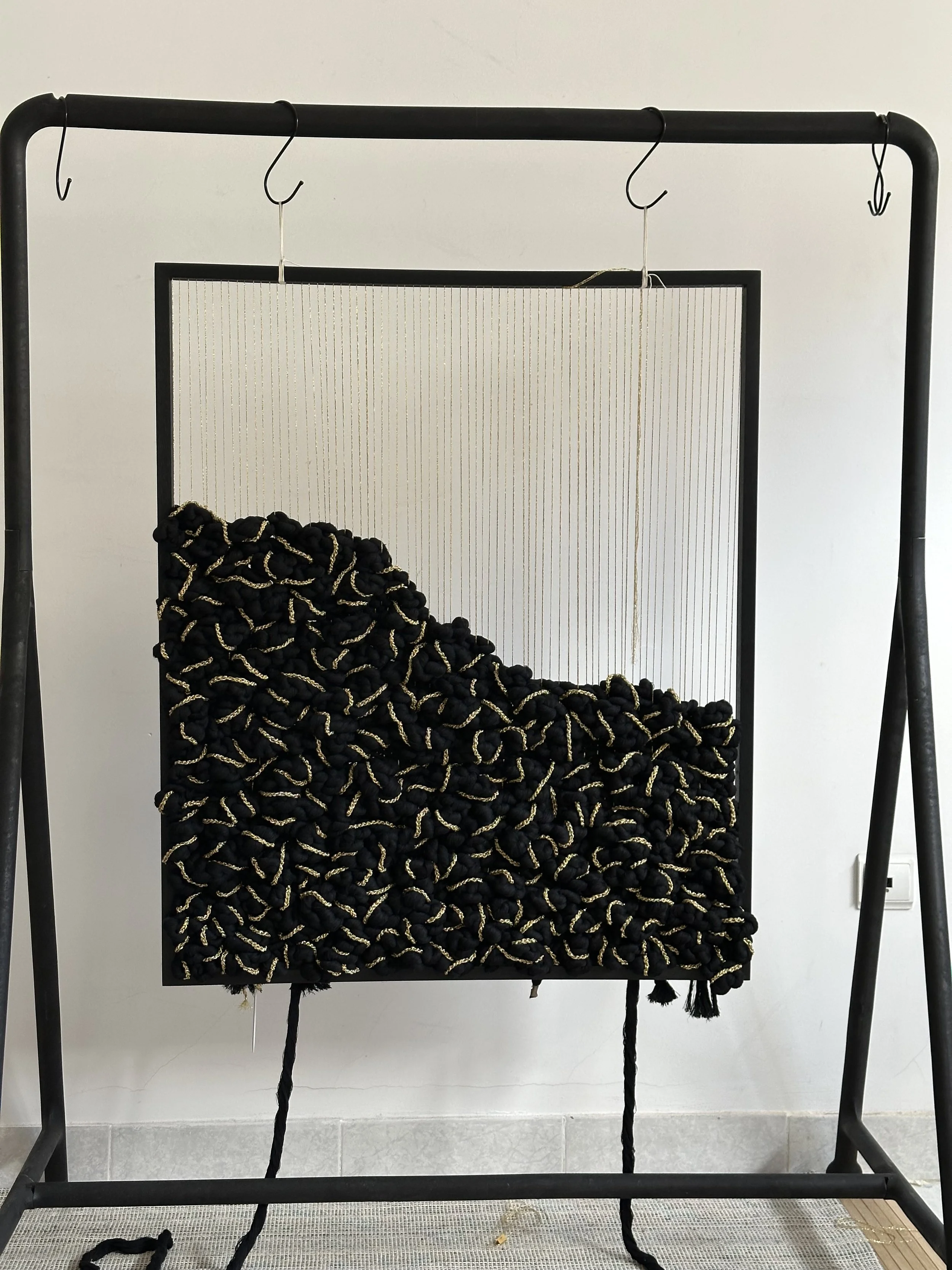 Textile art piece with black and gold fibers progress shot | Ana Salazar Atelier