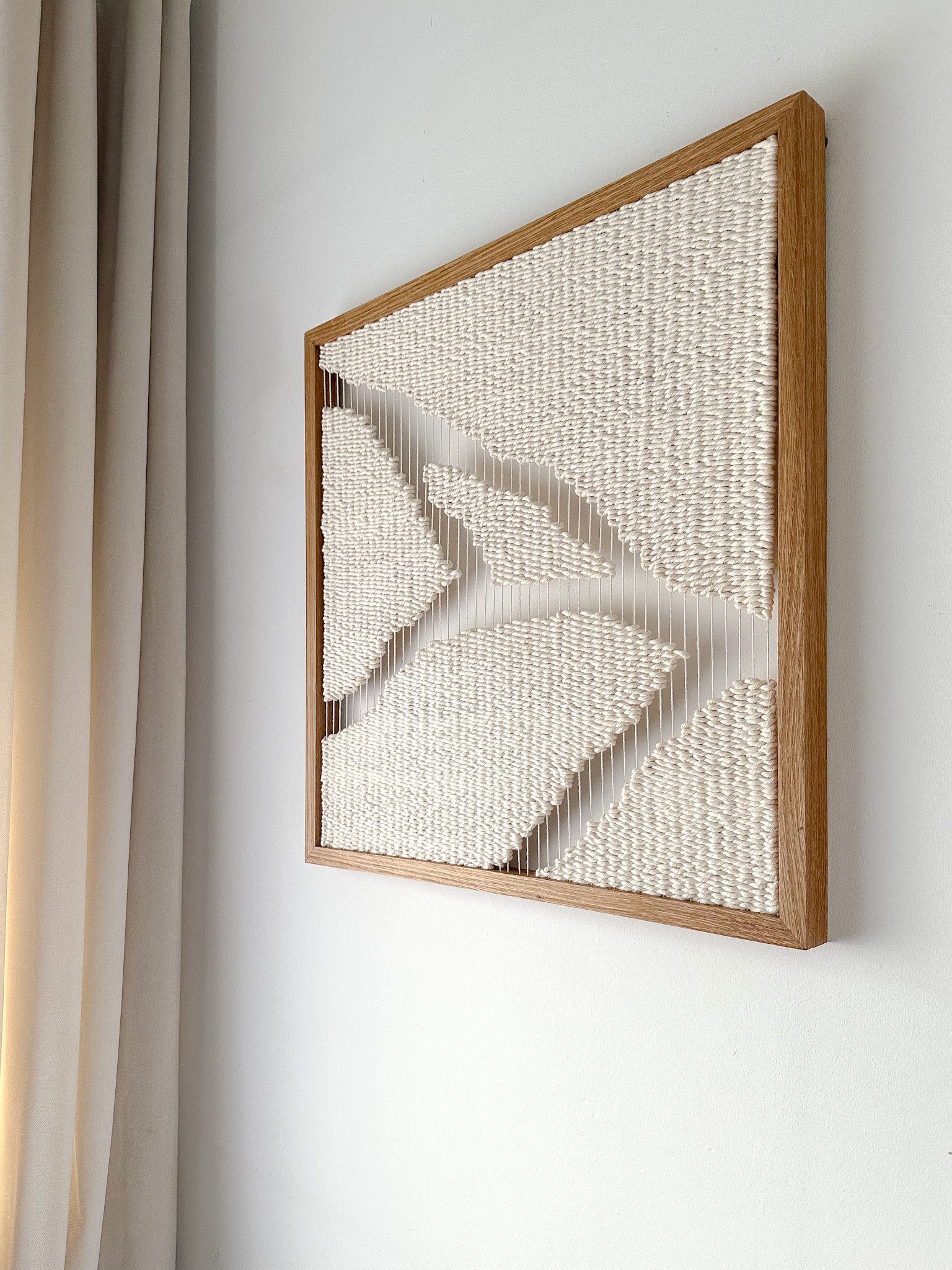 Large-scale framed textile art installed in a room with natural indirect light and soft shadows | Ana Salazar Atelier