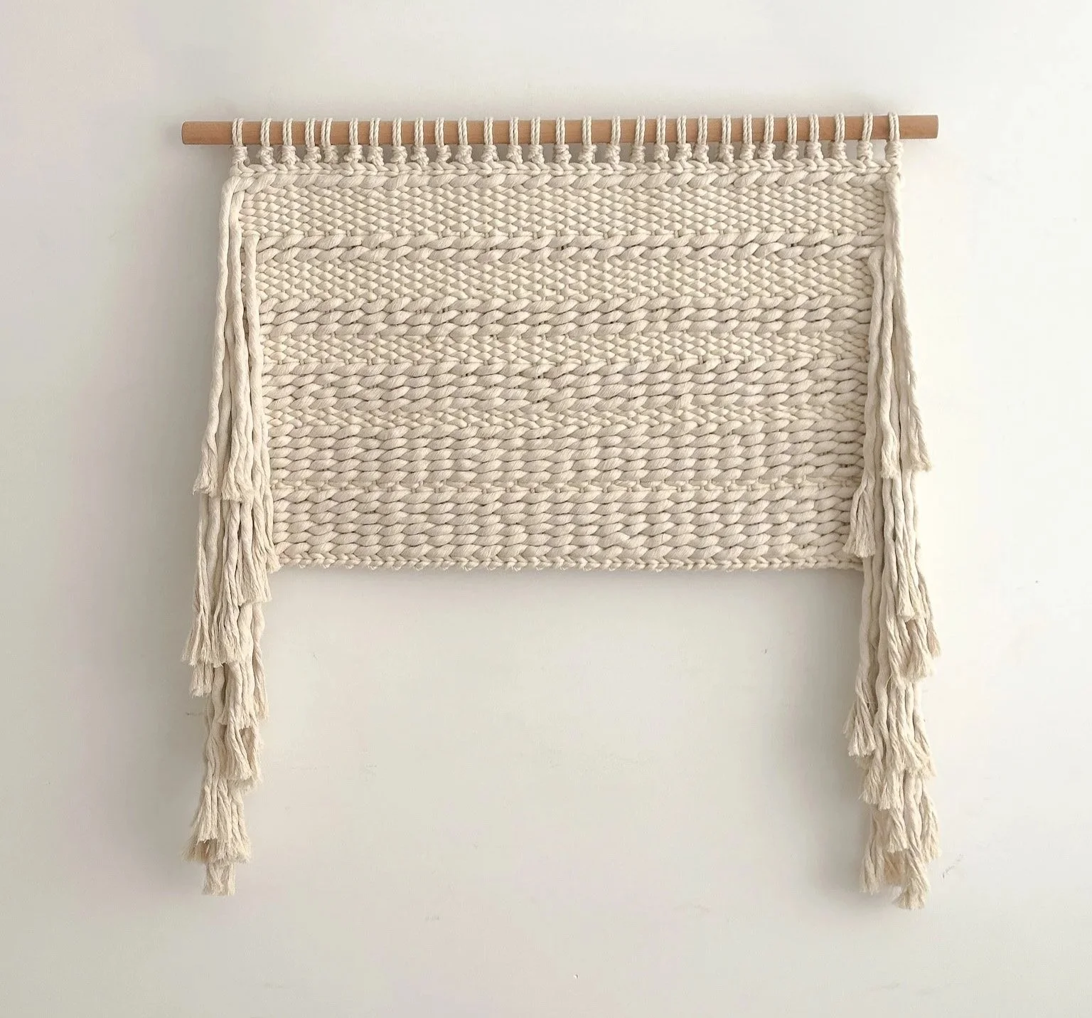 Large scale weaving tapestry hanging from a oak dowel, in neutral tones and side fringes | Ana Salazar Atelier