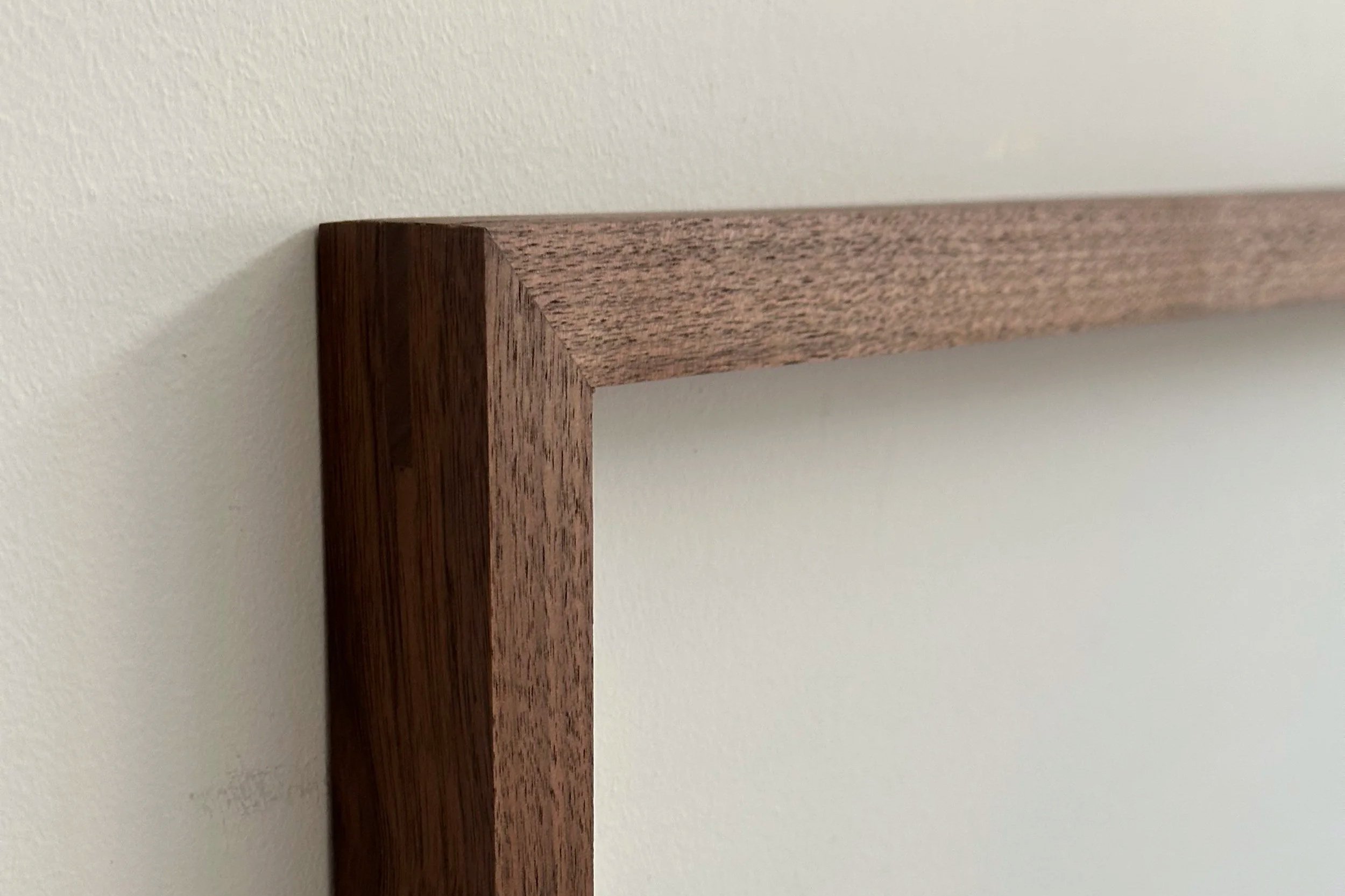 Close-up of traditional metal-free woodworking joinery on a solid walnut frame for textile art | Ana Salazar Atelier