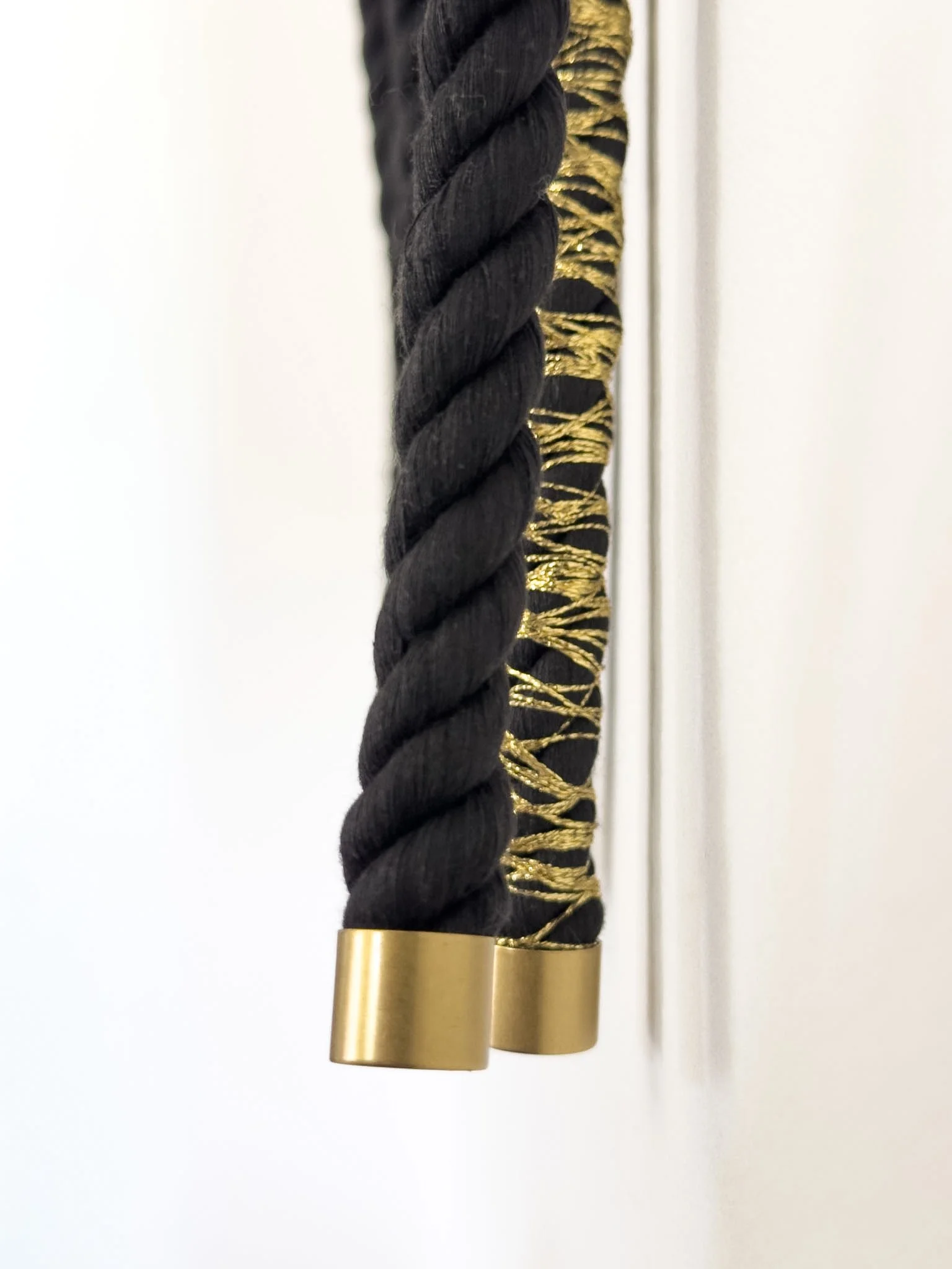 brass detailing on large bespoke rope install in black and gold | Ana Salazar Atelier.JPG