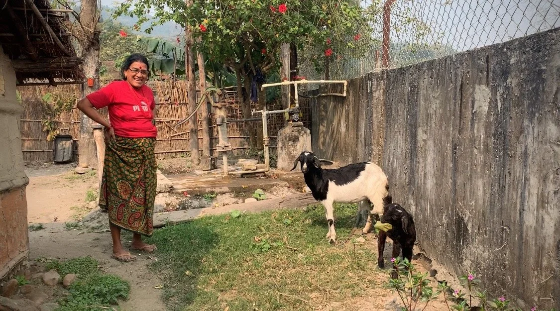 A woman and her goats in rural Nepal.