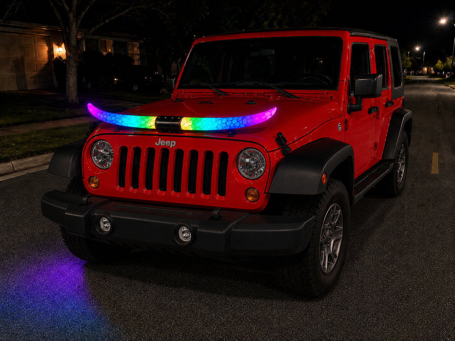 Red Jeep Wranger parked on a street at night with colorful glowing horn lights shaped like a rainbow and reflecting on the pavement.