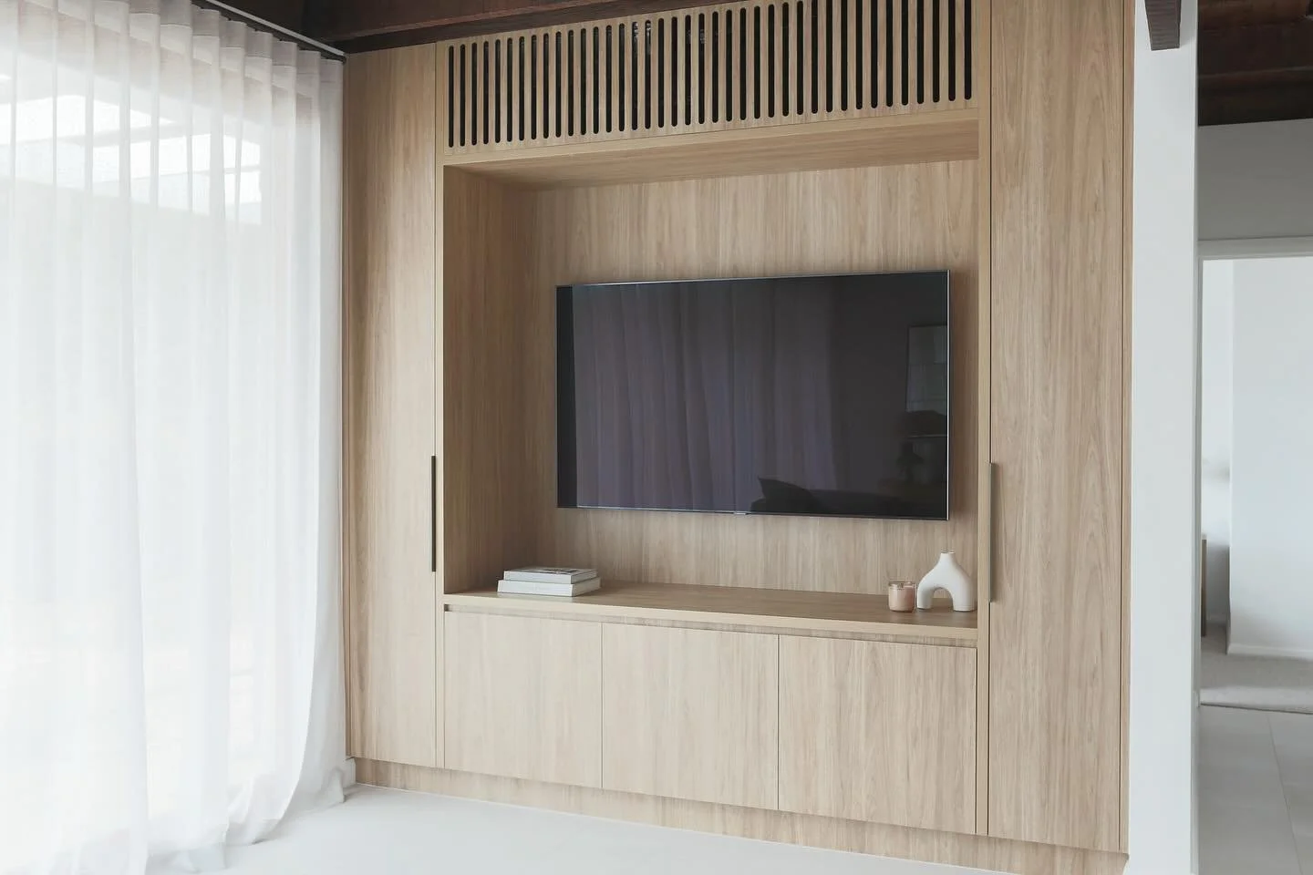 A beautiful but functional tv unit at our Willora project that&rsquo;s seamlessly hides all the toys, electronics and heating &amp; cooling. Designed by us using @polytec and made the talented @vsk_joinery