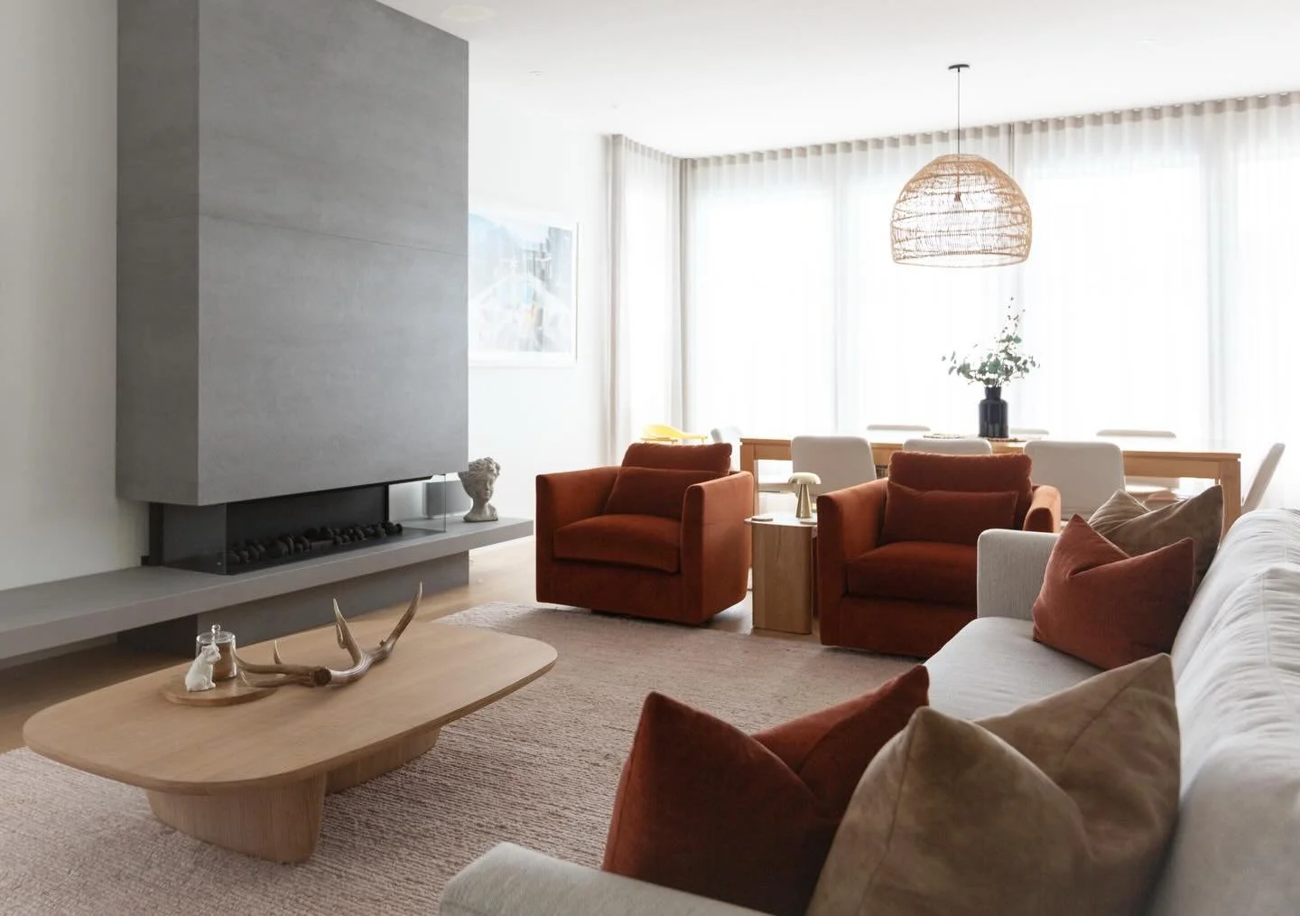 FURNITURE STYLING / we gave this living room a makeover including designing a new fireplace and installing some soft sheers. The new furniture includes our Harper chair upholstered in a soft copper velvet, our Emmett sofa and a custom blush rug. Clic