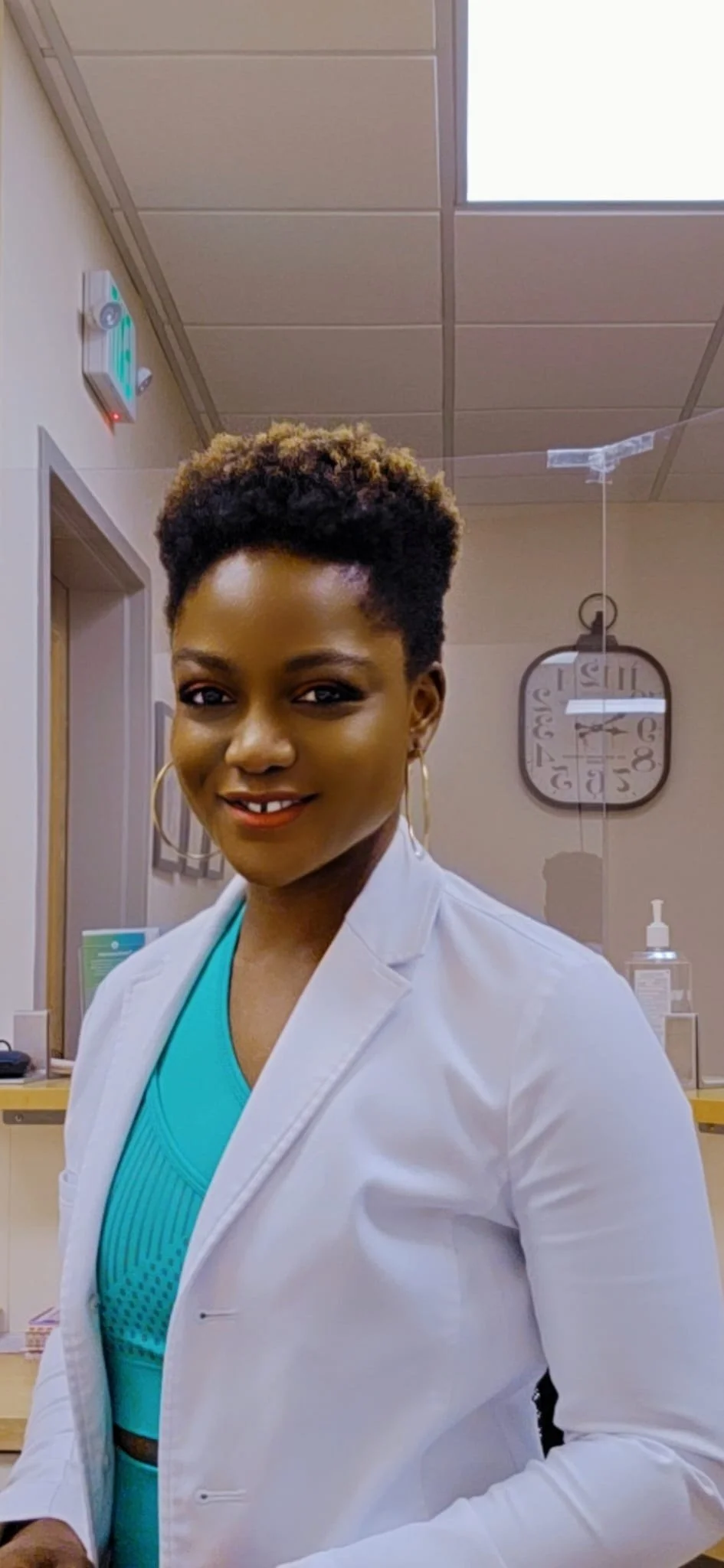 Vera Nyonglemuga, FNP-BC, FNP-C, MSCP Candidate, smiling in a clinical setting, wearing a light blazer.